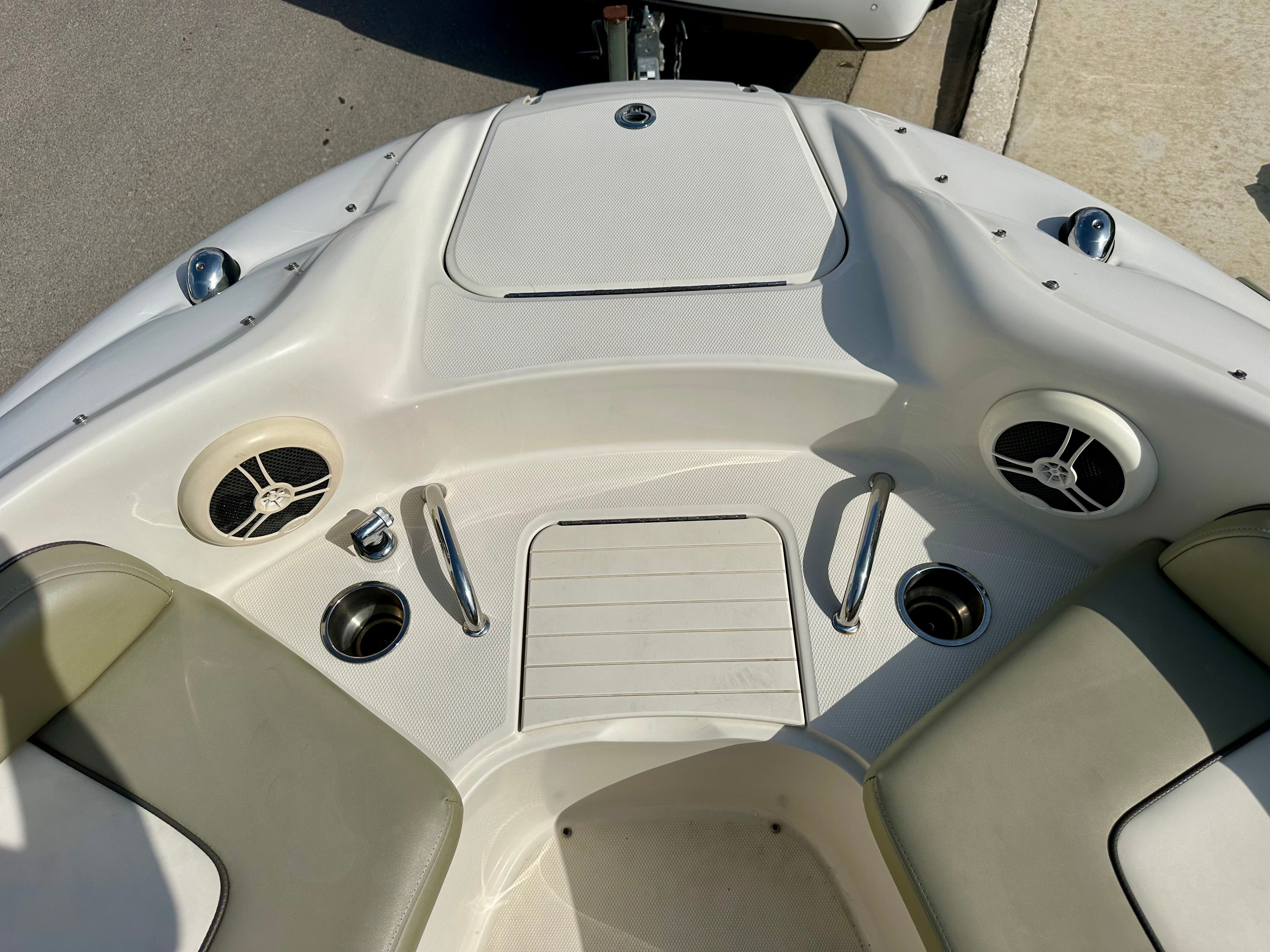 Interior of a 2006 Sea Ray 240 Sundeck boat with speakers.
