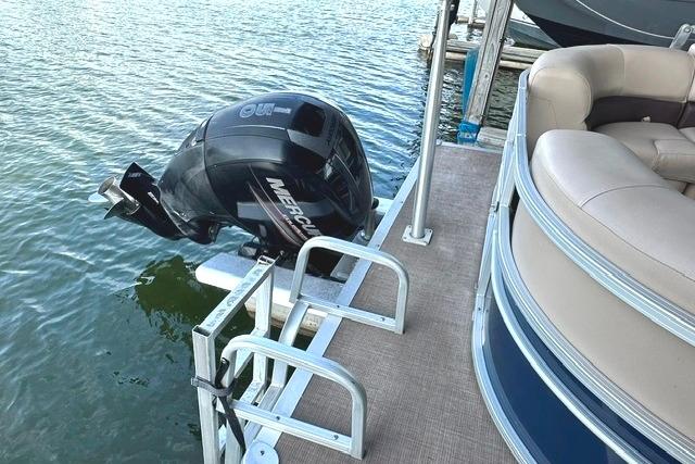 2019 Sun Tracker Party Barge 22 XP3 with Mercury outboard motor on a lake.