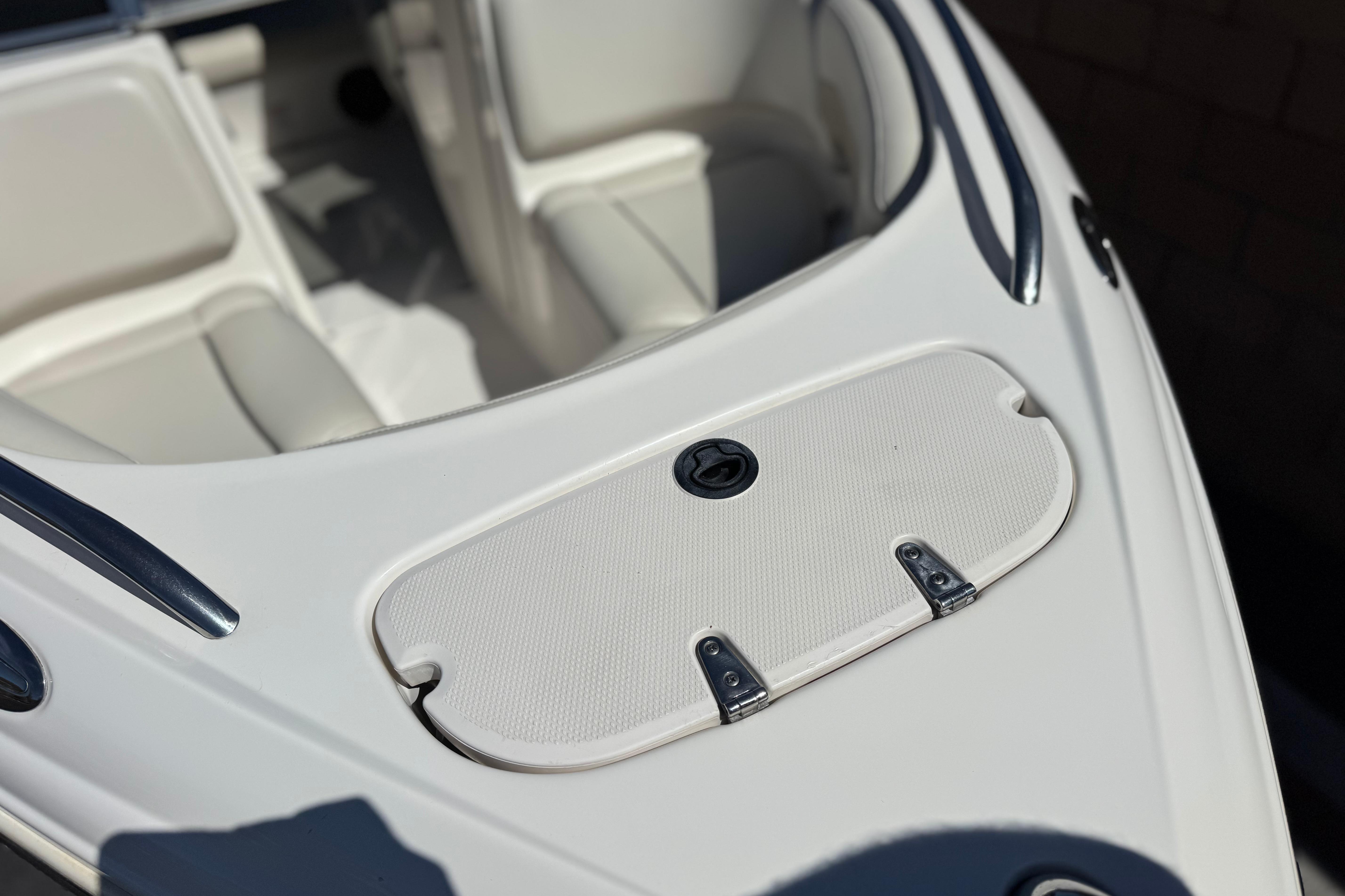 2002 Chaparral 186 SSi boat bow with storage compartment and seating area.