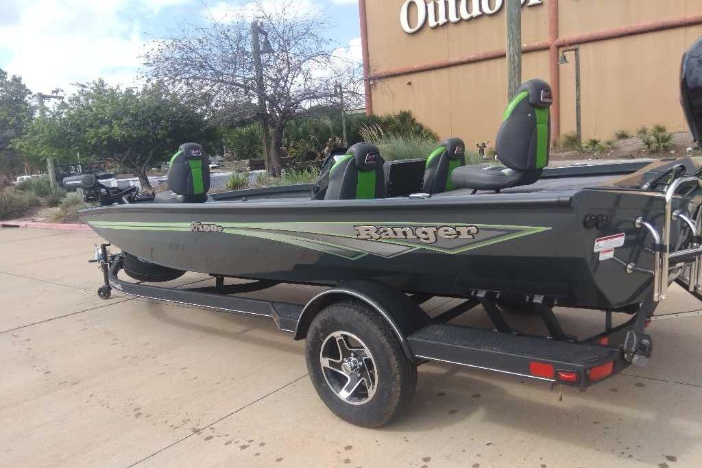 2026 Ranger RT198P boat with green accents on a trailer, parked outdoors.