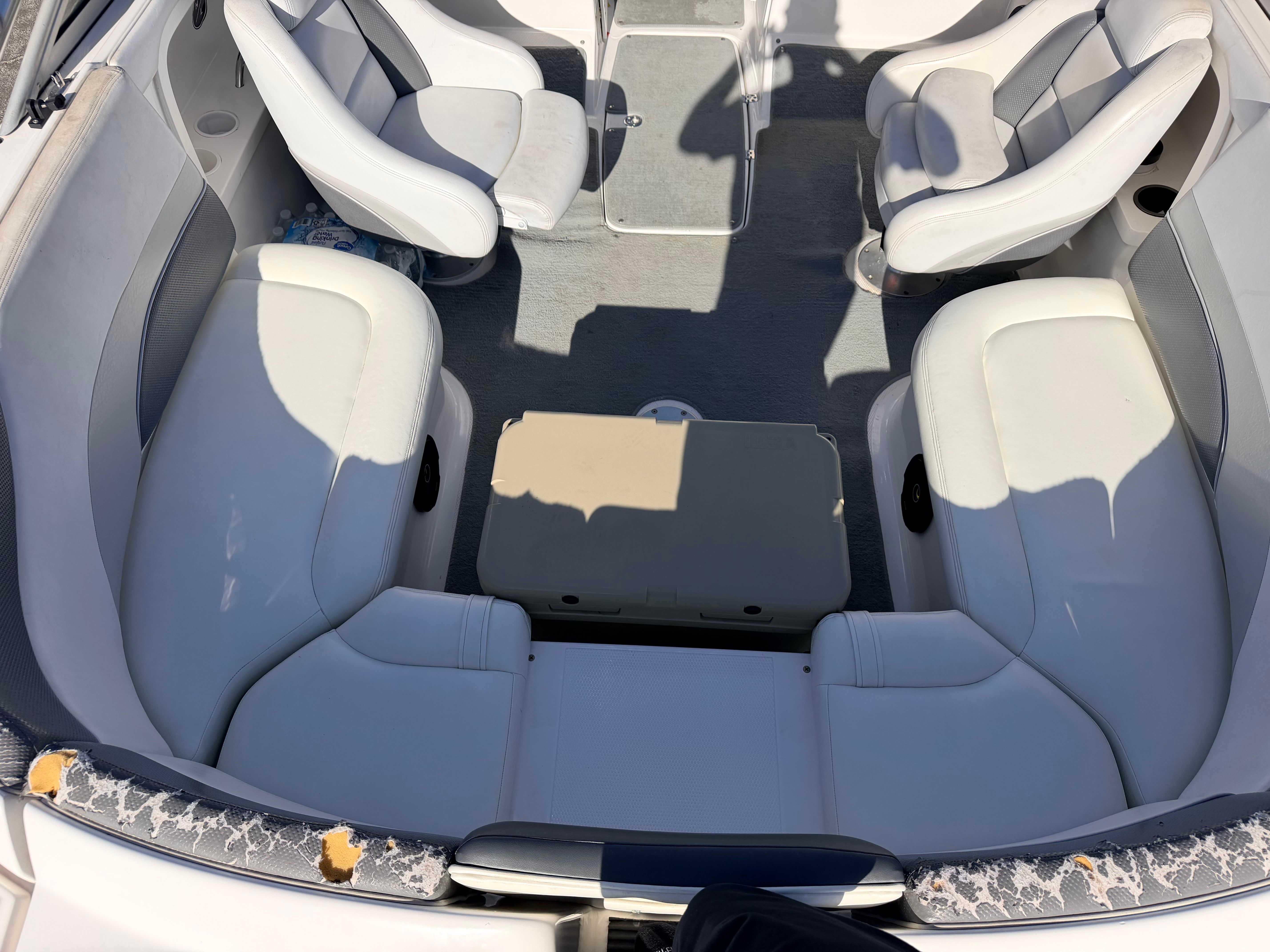 Interior view of a 2005 Yamaha AR230 boat with white seats and gray carpet.