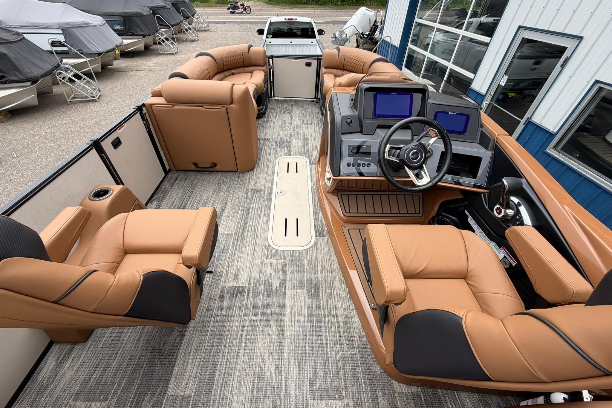 2026 Avalon Catalina Quad Lounge Shift boat interior with luxurious tan seating and modern dashboard.