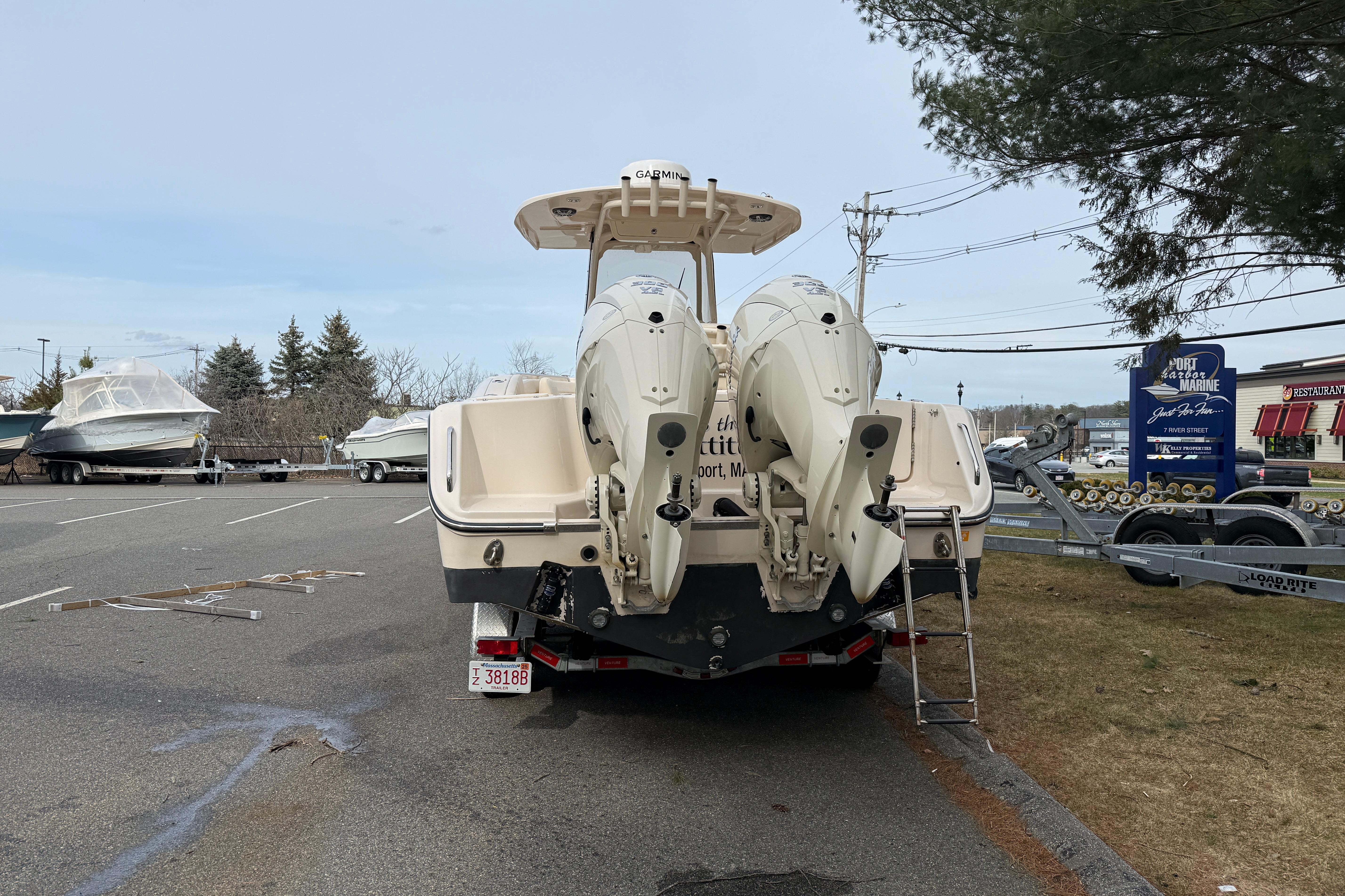 2024 Grady-White Canyon 271 boat with dual engines in a parking lot.