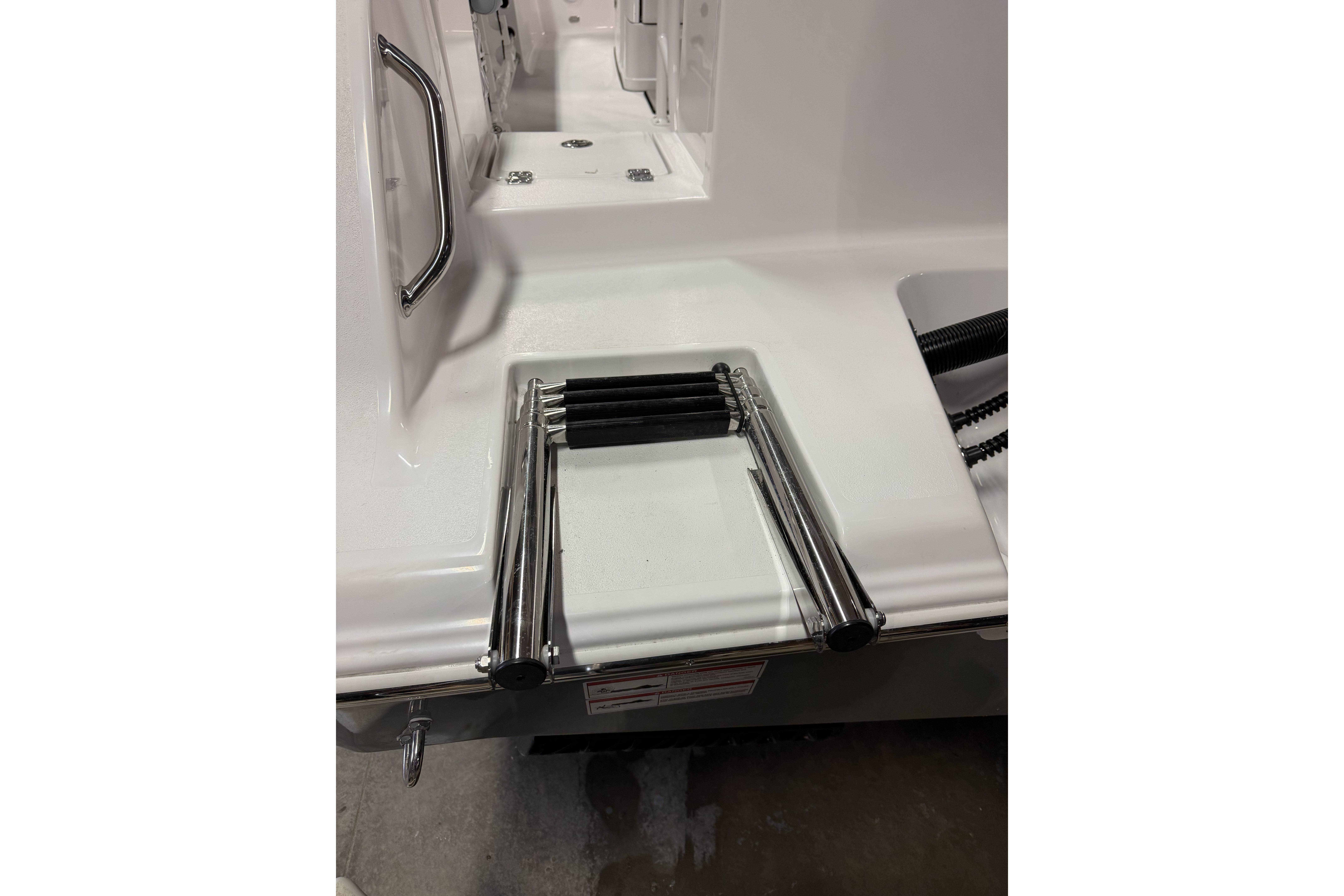 2026 Sportsman Open 232 Center Console boat with stainless steel swim ladder.