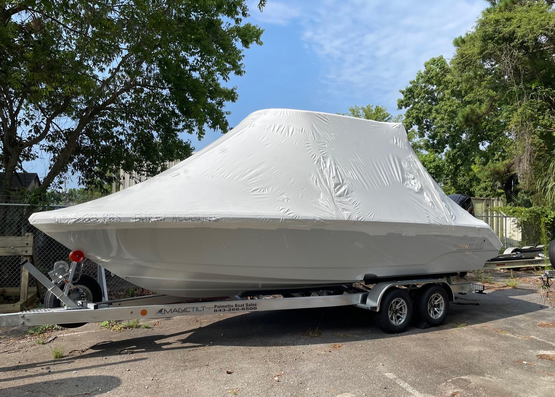 2024 Pathfinder 2400 Open boat covered on trailer, parked outdoors.