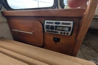 Interior with wooden panel and stereo system.