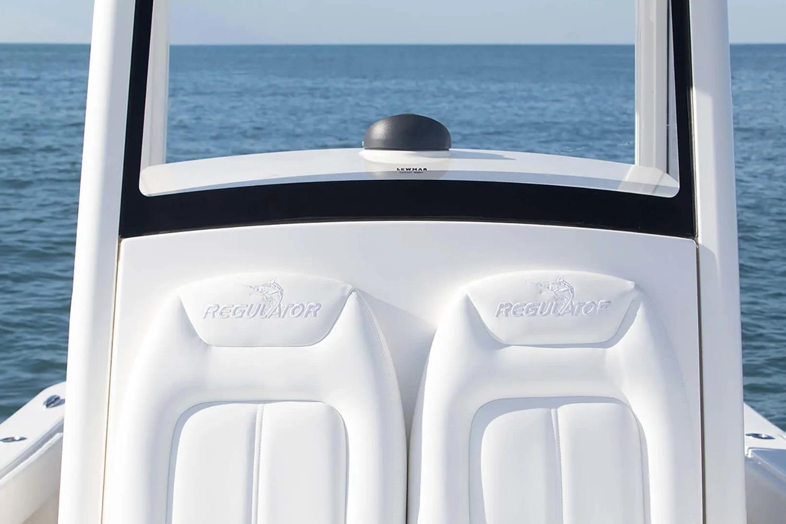 2027 Regulator 24XO boat seats with logo, ocean backdrop.