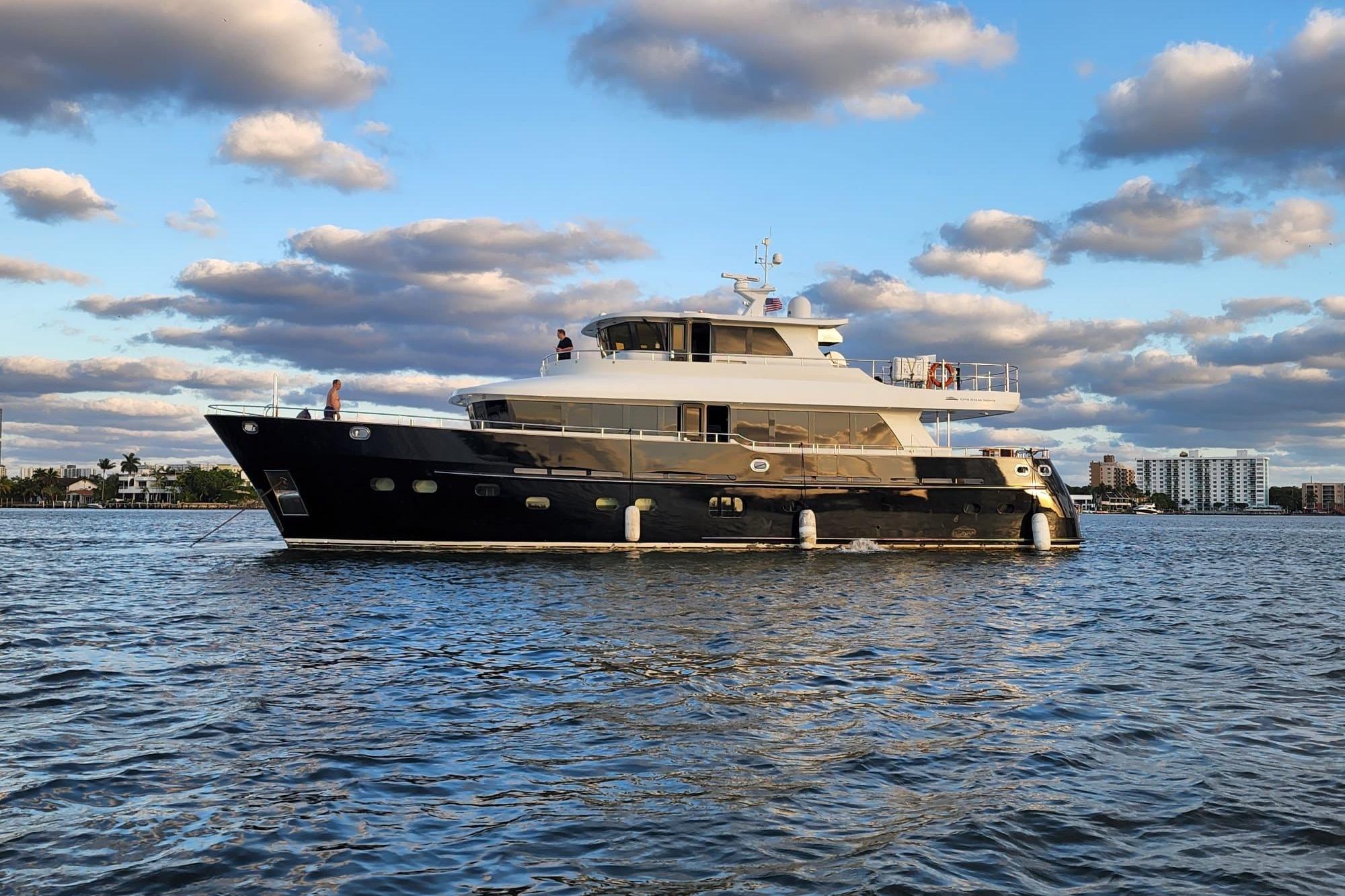 2014 Fifth Ocean Yachts 24m Displacement Explorer Yacht on calm water under cloudy sky.