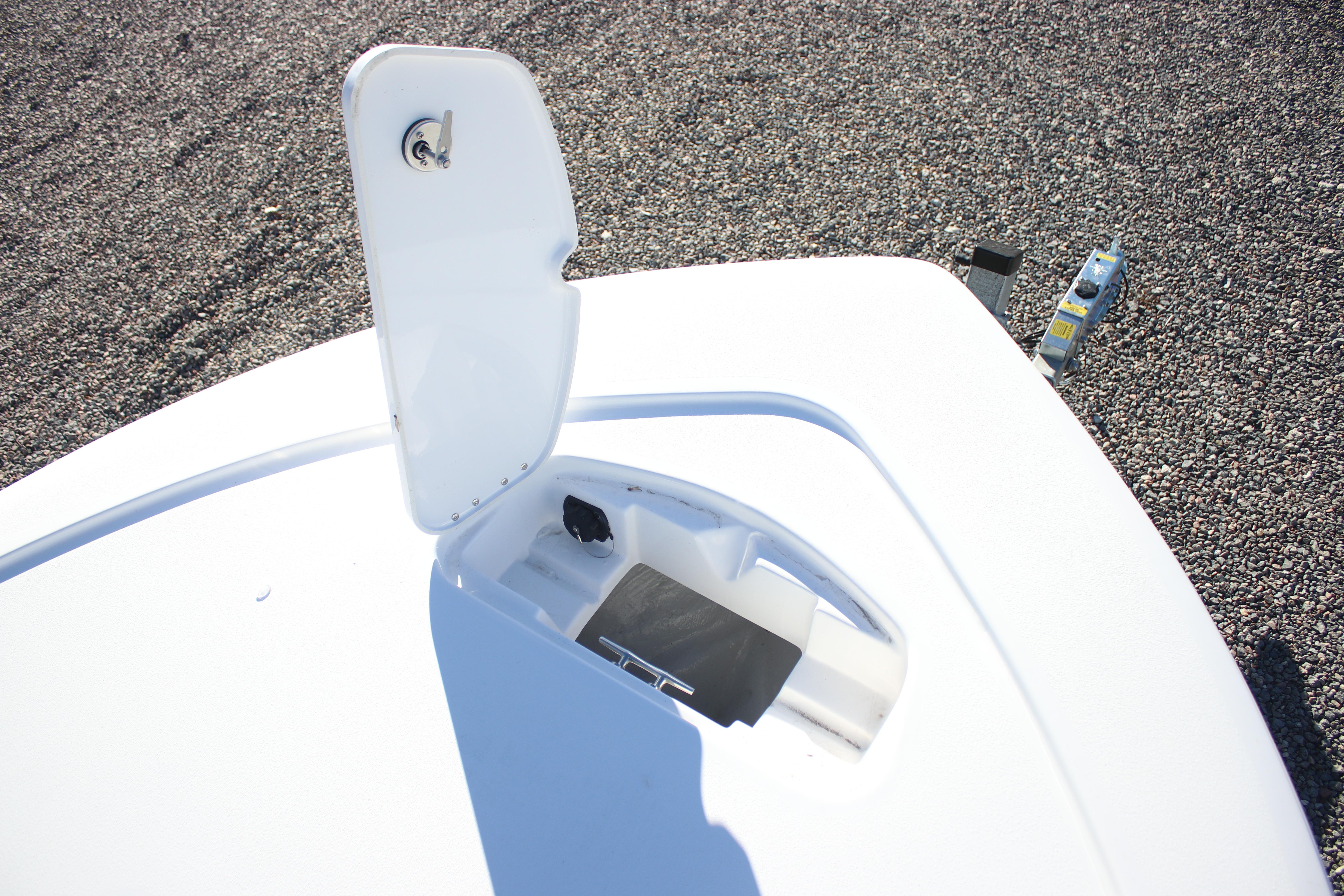 Open hatch on 2026 Tidewater 2210 Carolina Bay boat, showing storage compartment.