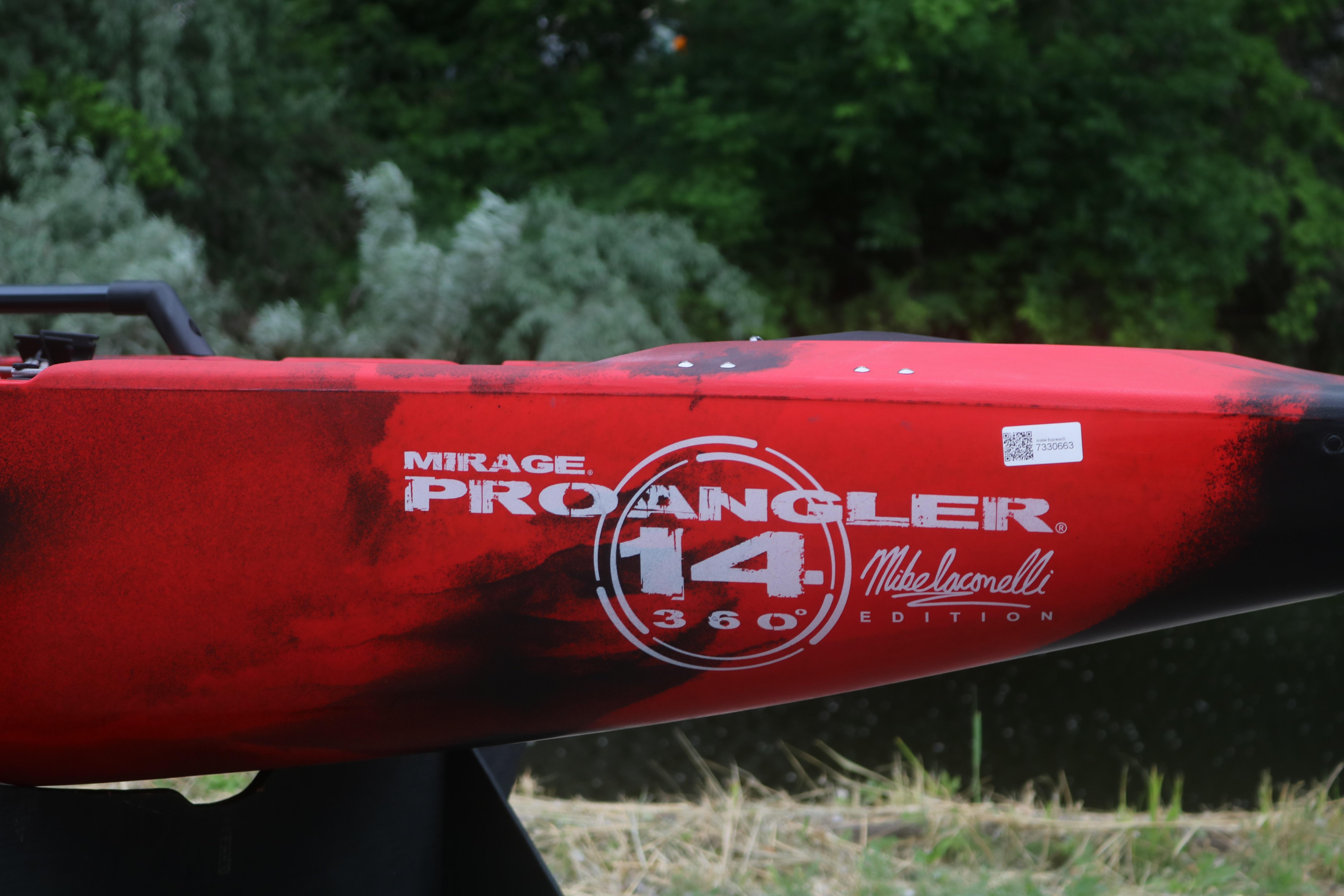 Red 2023 Hobie Mirage Pro Angler 14 kayak, Mike Iaconelli edition, near lush greenery.