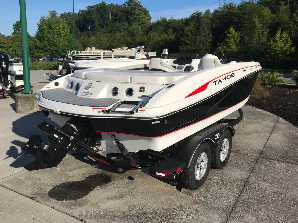 2023 Tahoe 210 Si Limited boat on a trailer, parked outdoors.