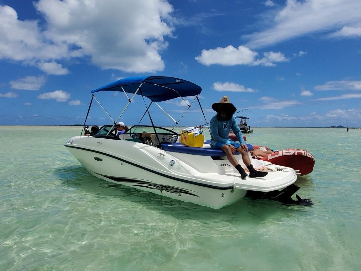 2011 Sea Ray 185 Sport boat on clear water with people.
