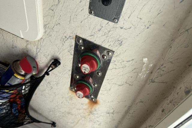 Red switches on a 2006 Sailfish 2660 CC boat interior wall.
