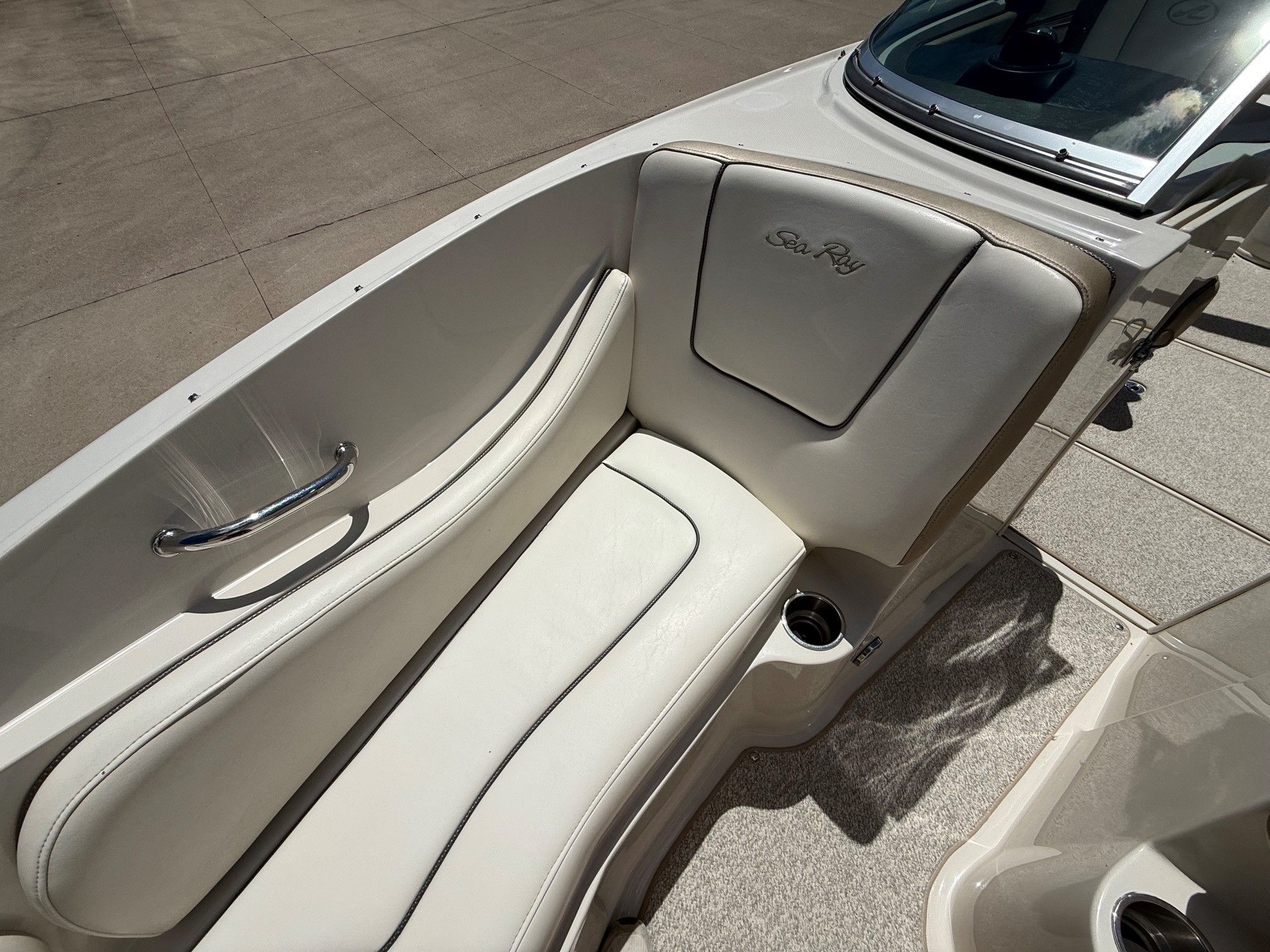Interior of a 2007 Sea Ray 230 Select boat with beige seating.