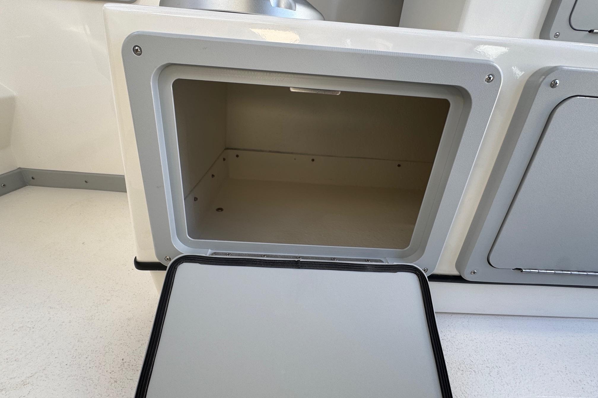 Open storage compartment on 2026 Defiance Admiral 250 EX boat.