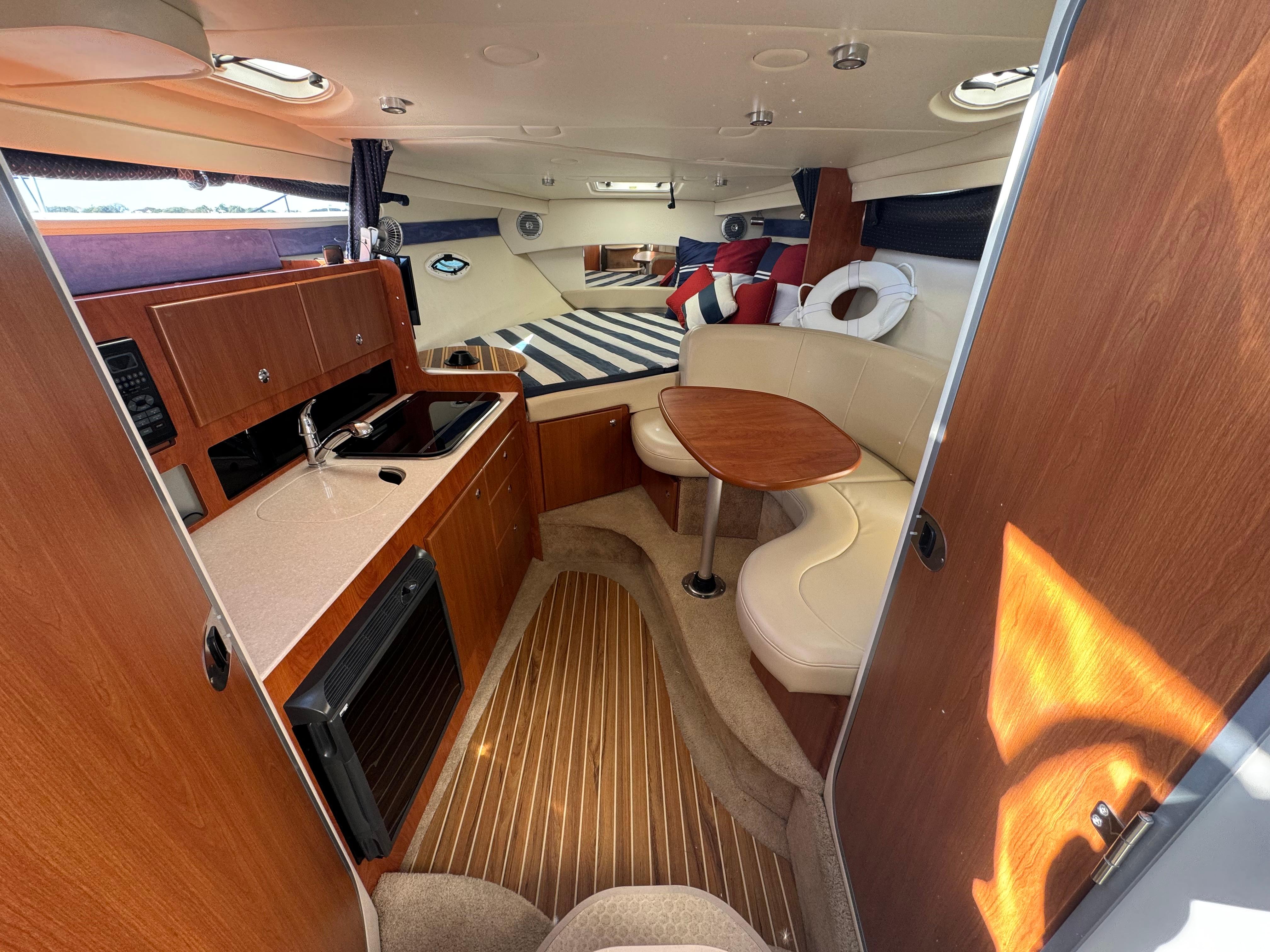2008 Bayliner 300 Ciera cabin interior with kitchenette and seating area.