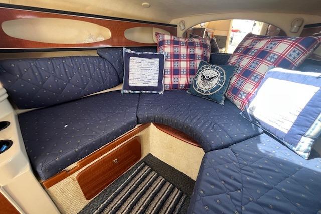 2003 Sea Ray 260 Sundancer cabin with cozy seating and decorative pillows.