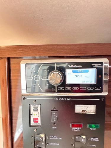 Control panel of a 2015 Sea Ray 260 Sundancer with radio and electrical switches.