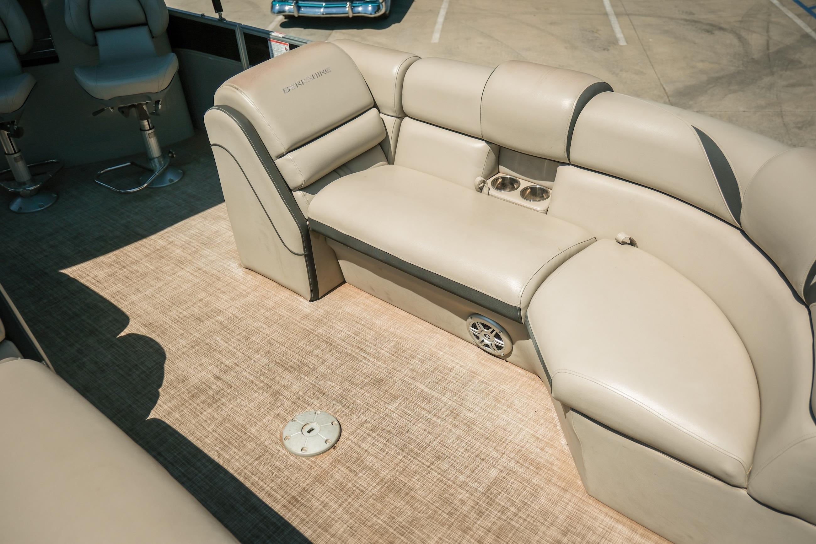 Interior of 2019 Berkshire 25CLE STS pontoon boat with beige seating and cup holders.