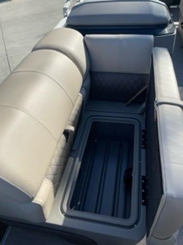 2024 Sun Tracker Fishin' Barge 20 DLX seating and storage compartment.