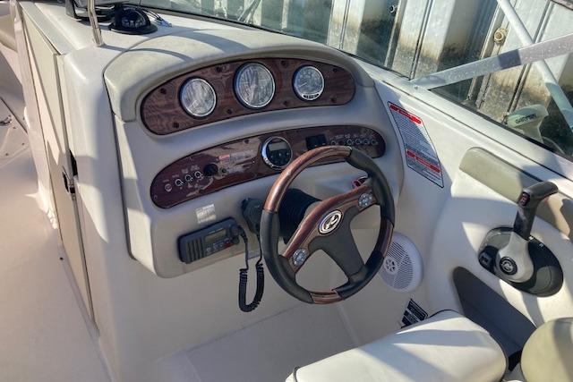 2006 Sea Ray 270 Sundeck dashboard with steering wheel and instrument panel.