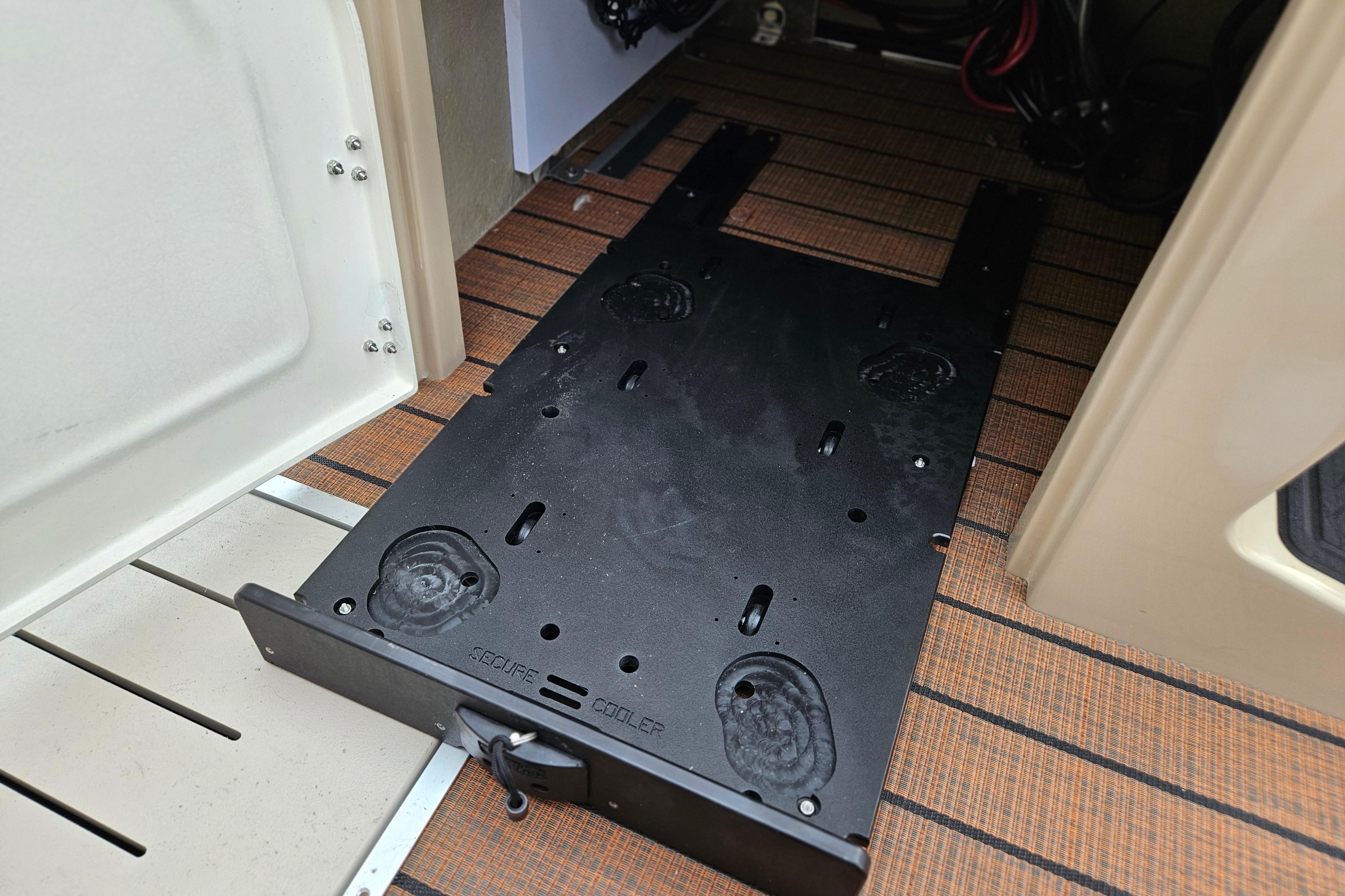 2026 Bentley Pontoons Legacy 243 Cruise interior with secure cooler compartment.