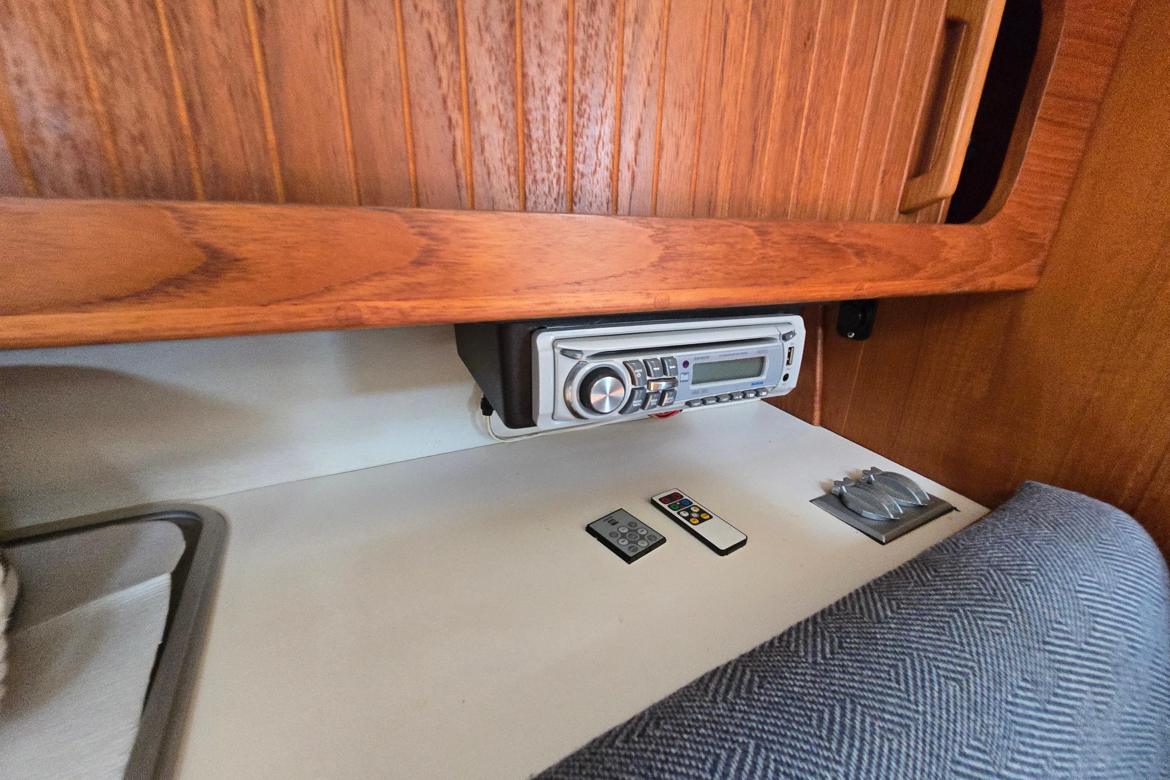 1993 Caliber 35 interior with wooden paneling, stereo system, and remote controls.