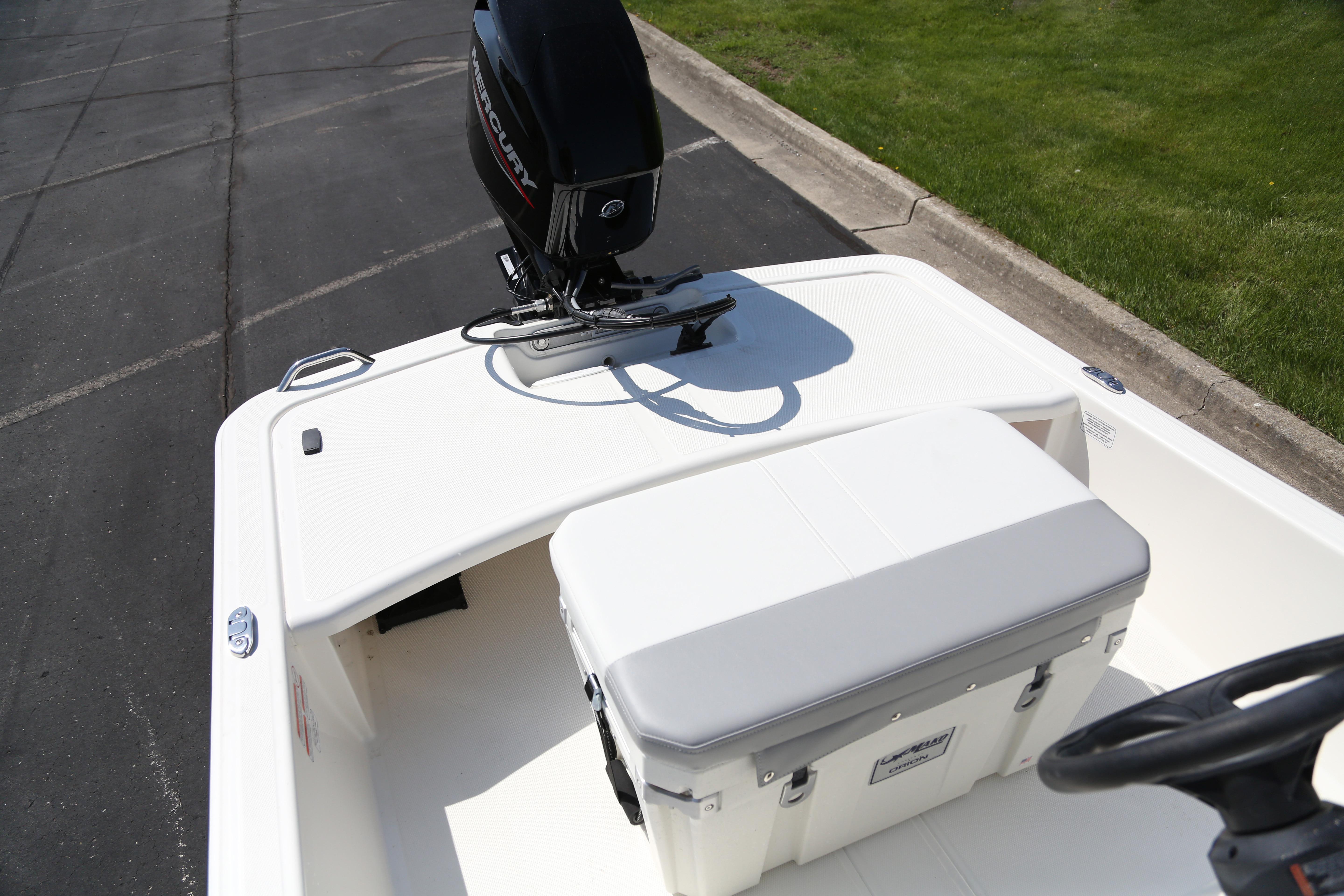 2026 Mako Pro Skiff 15 CC boat with Mercury outboard motor, parked on pavement.