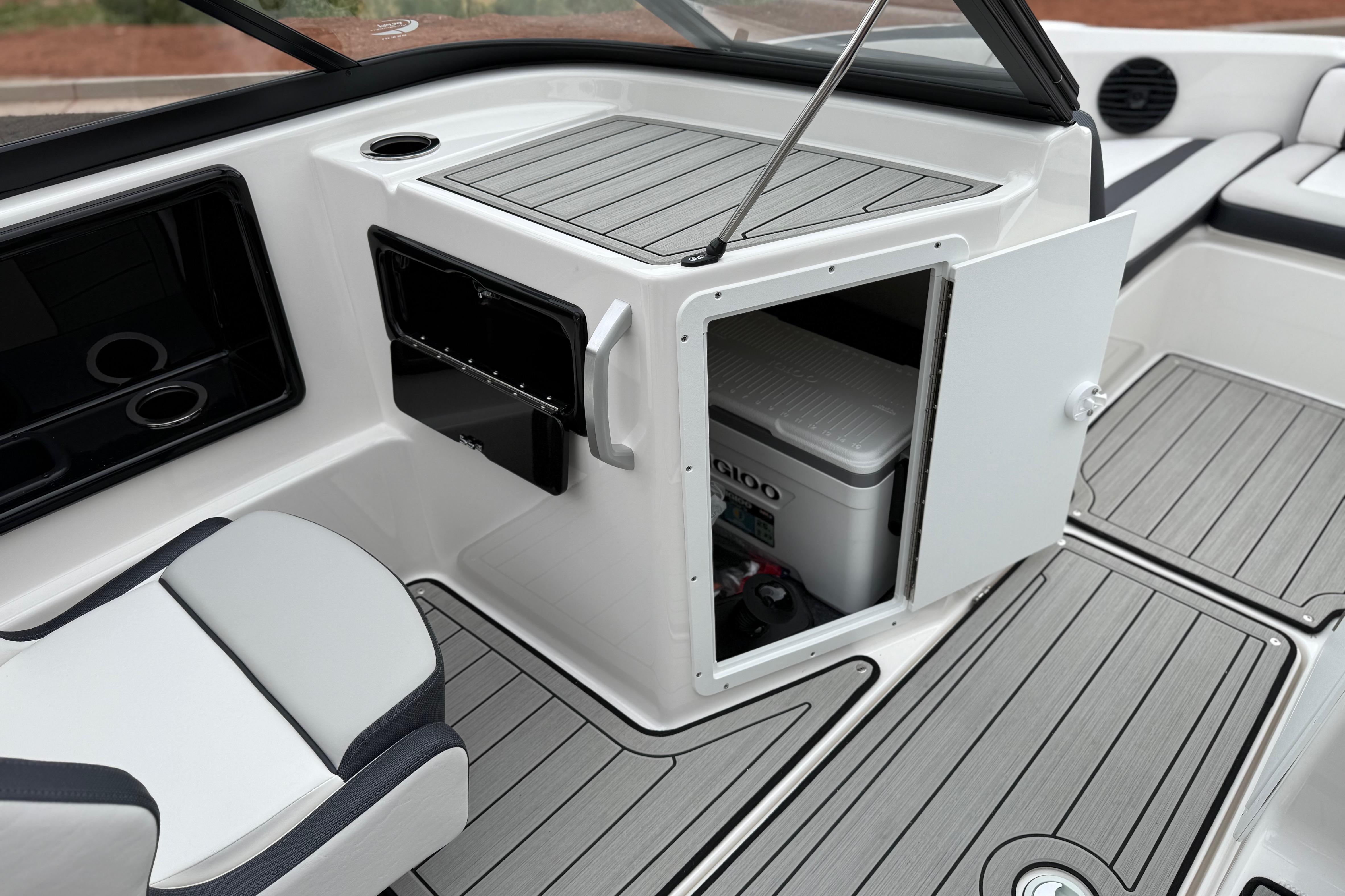 Interior of 2025 Yamaha Boats 195S, featuring storage compartment and seating area.