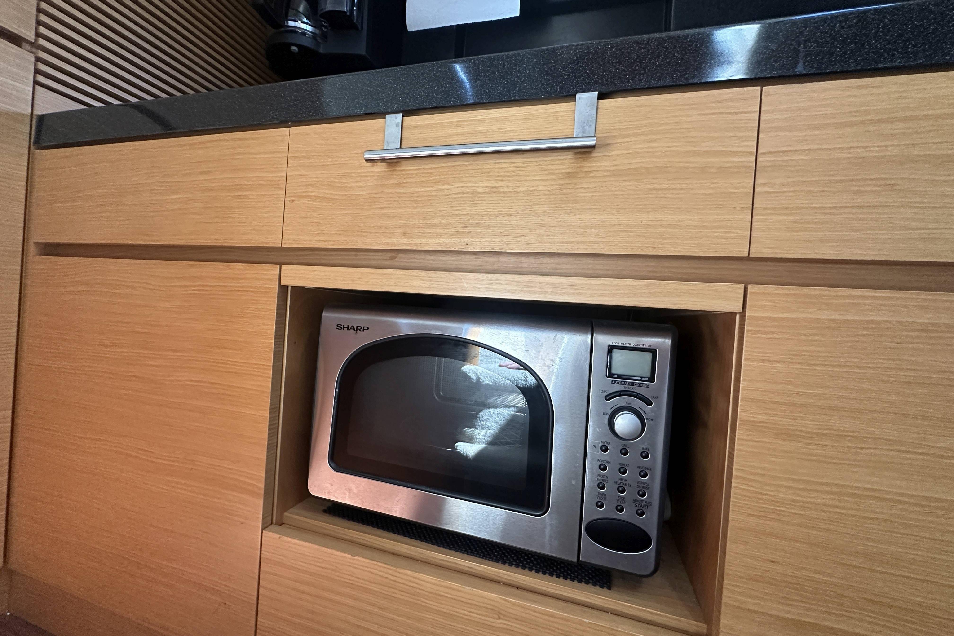 Microwave in wooden cabinet on 2007 Azimut 43 yacht kitchen.
