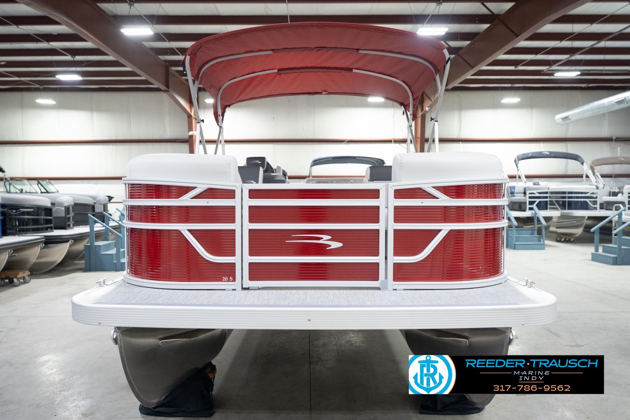 2026 Bennington 20 SL pontoon boat with red exterior in a showroom.
