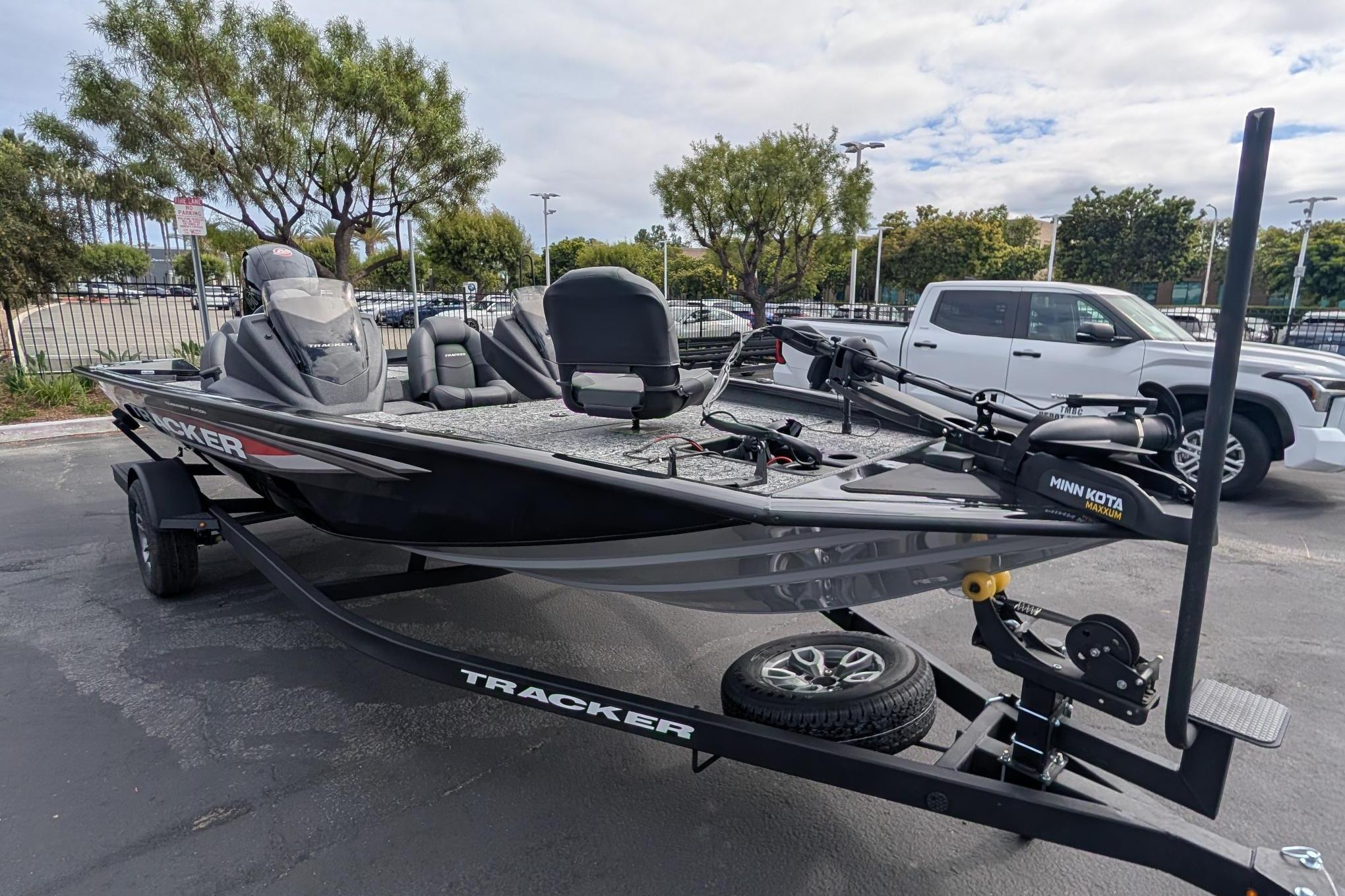 2026 Tracker Pro Team 195 fishing boat on trailer, parked outdoors.