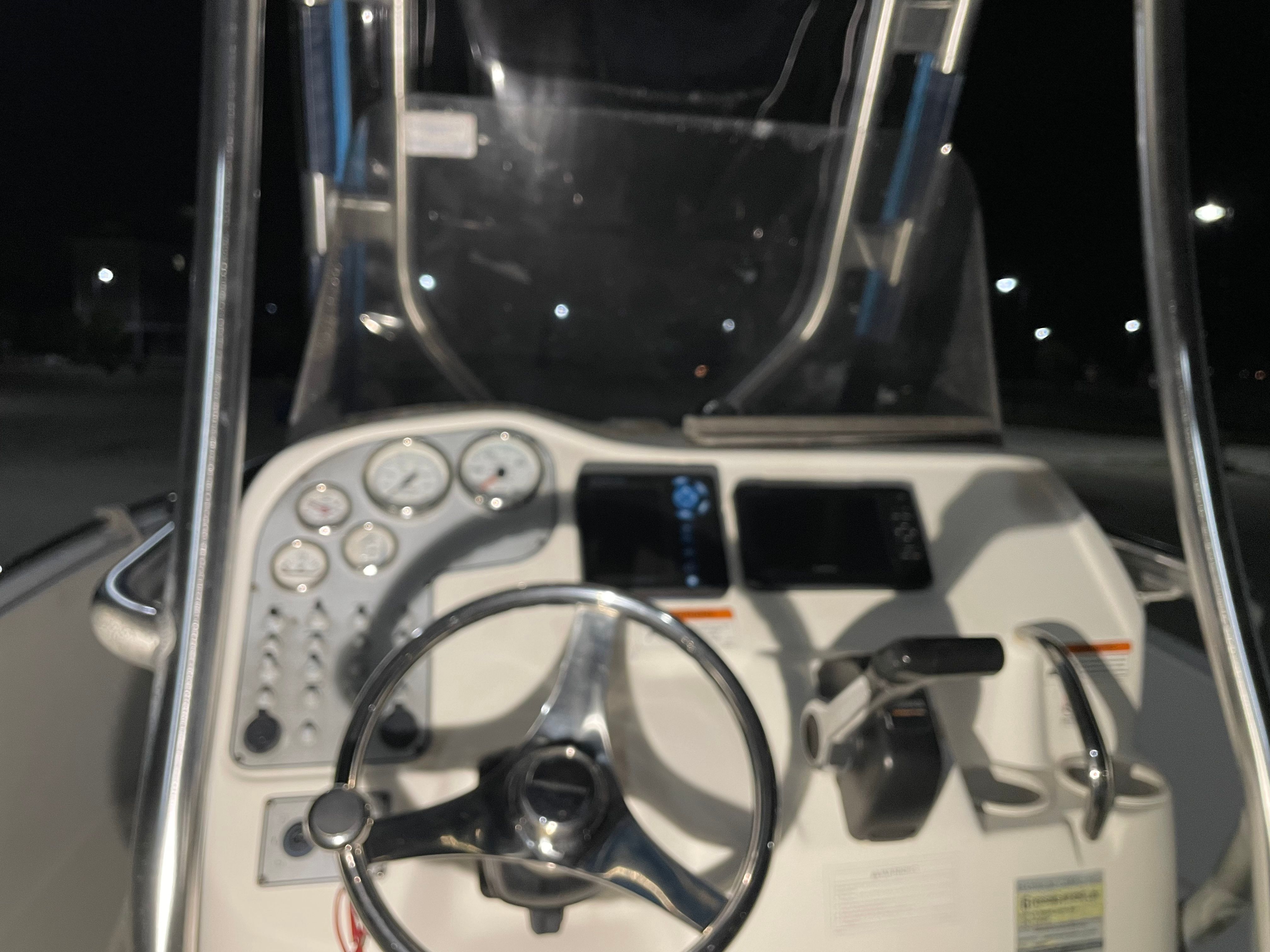 Dashboard of a 2005 Aquasport 210 Osprey at night.
