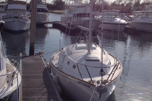 1980 Sloop 27.7 Bristol sailboat docked at marina with other boats.