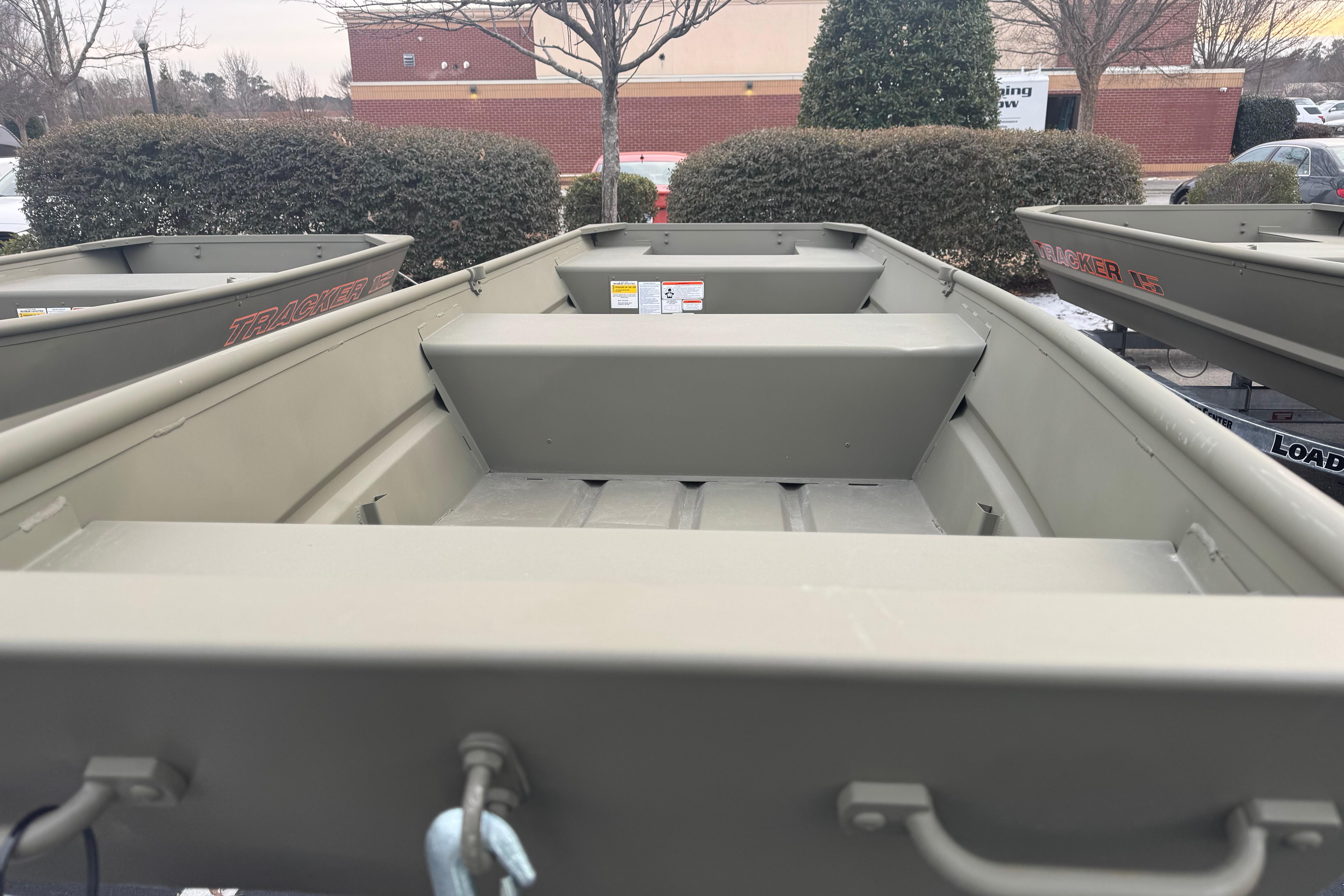 2026 Tracker Grizzly 14 Jon boat, parked outdoors, showcasing interior seating and design.