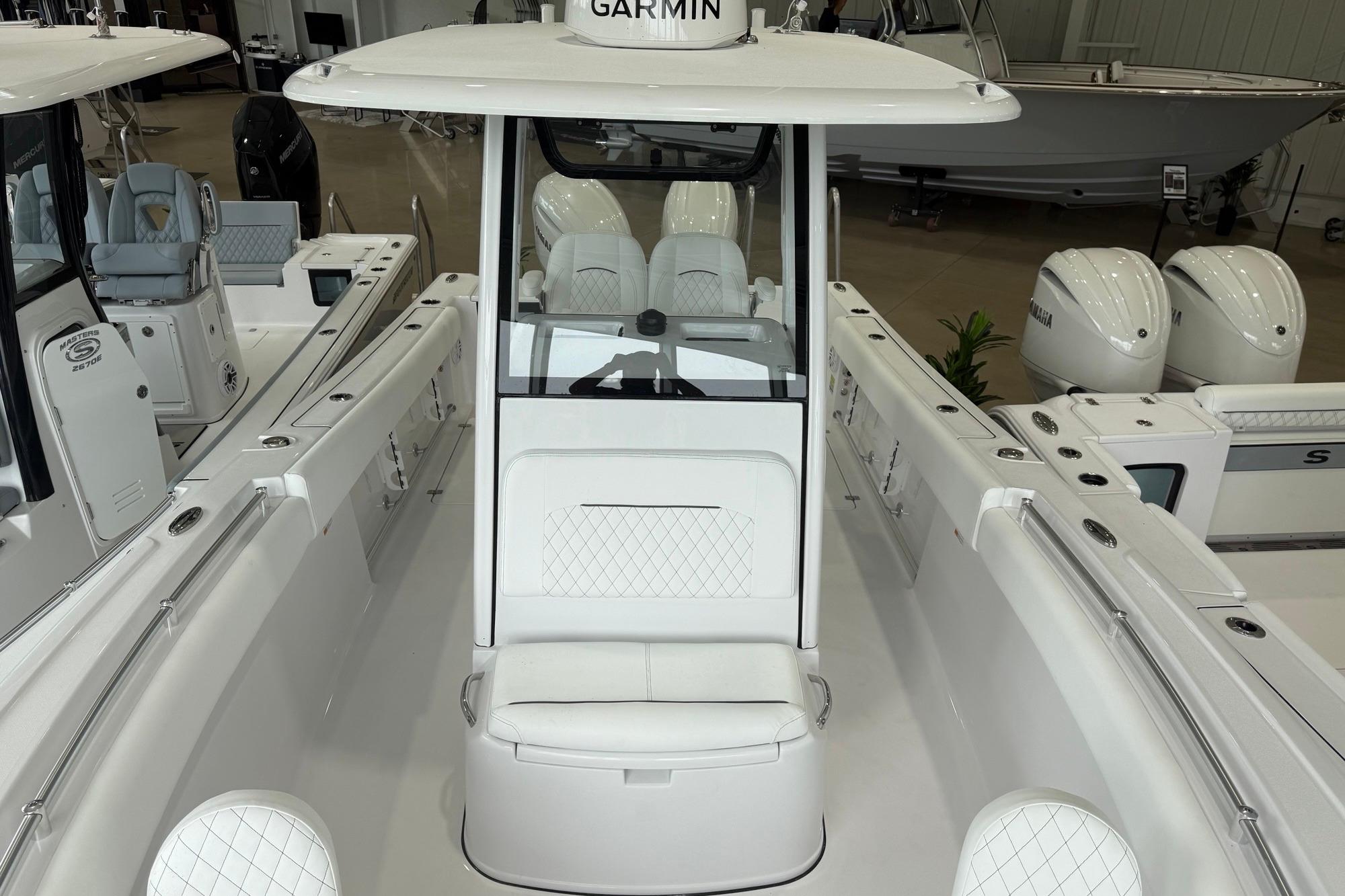2026 Sportsman Open 252 Center Console boat with white seating and Garmin equipment.