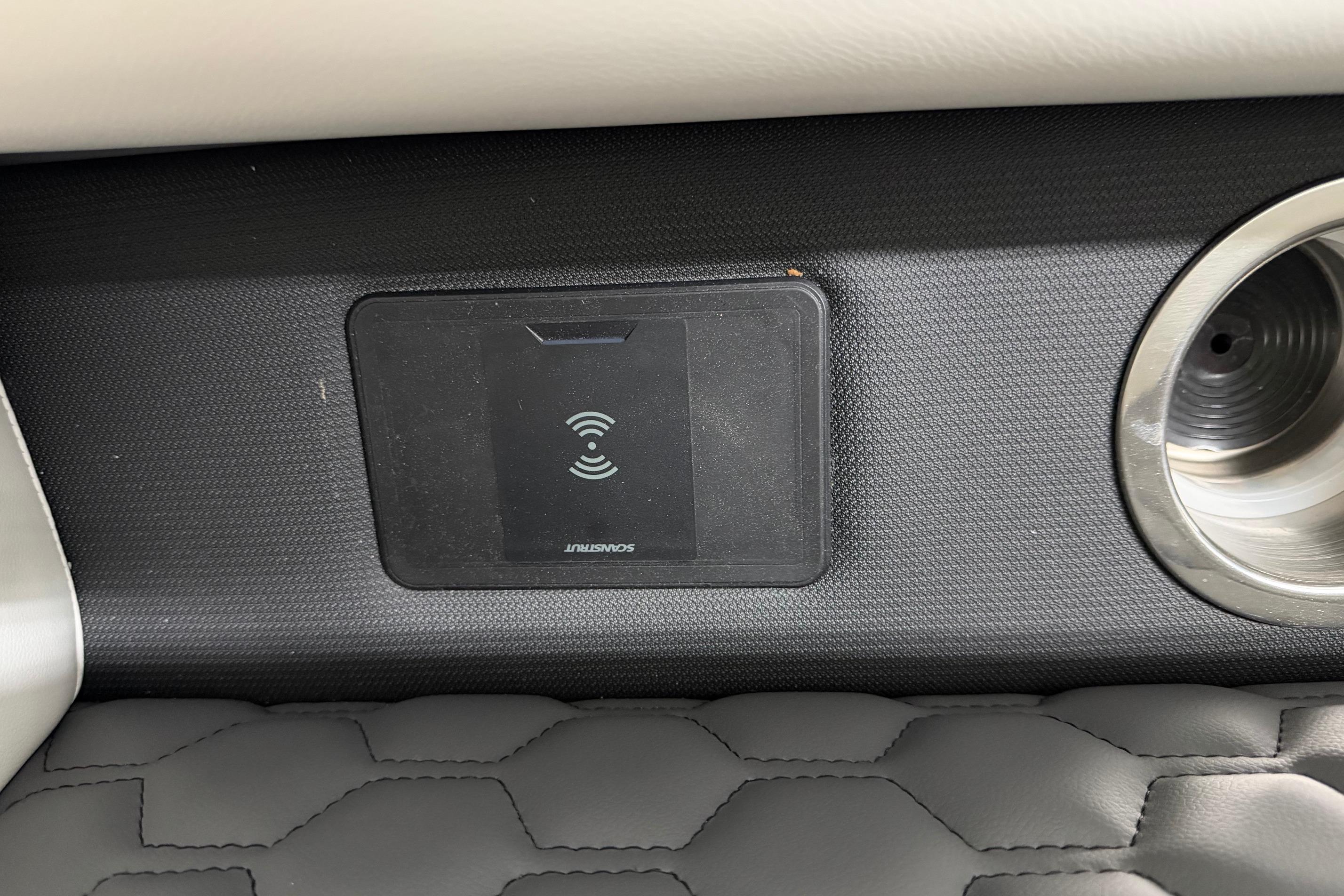 Wireless charging pad in 2026 South Bay 525SB2 boat interior, featuring sleek design and cup holder.