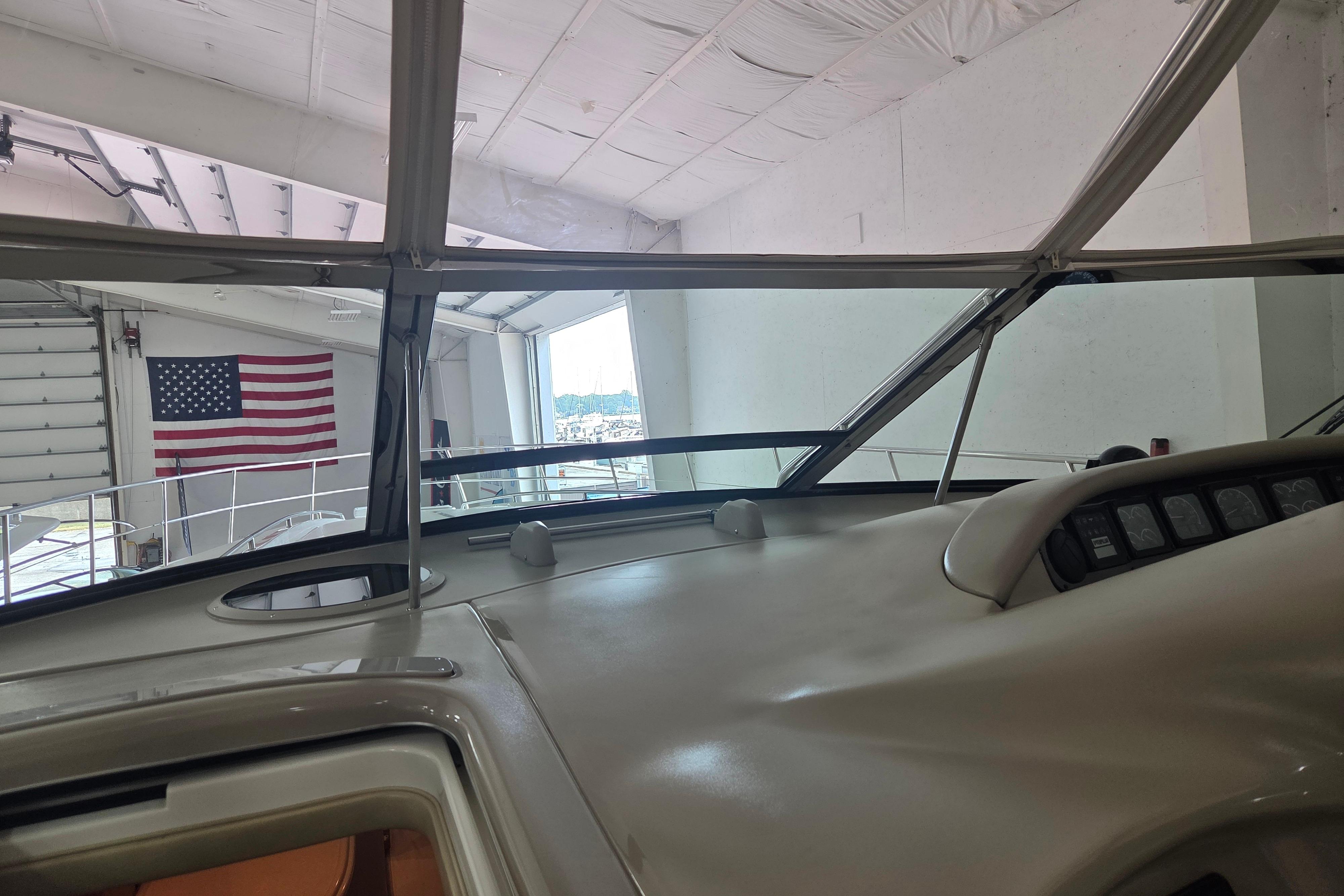 Interior view of 2000 Sea Ray Sundancer 540 yacht in a marina with American flag.