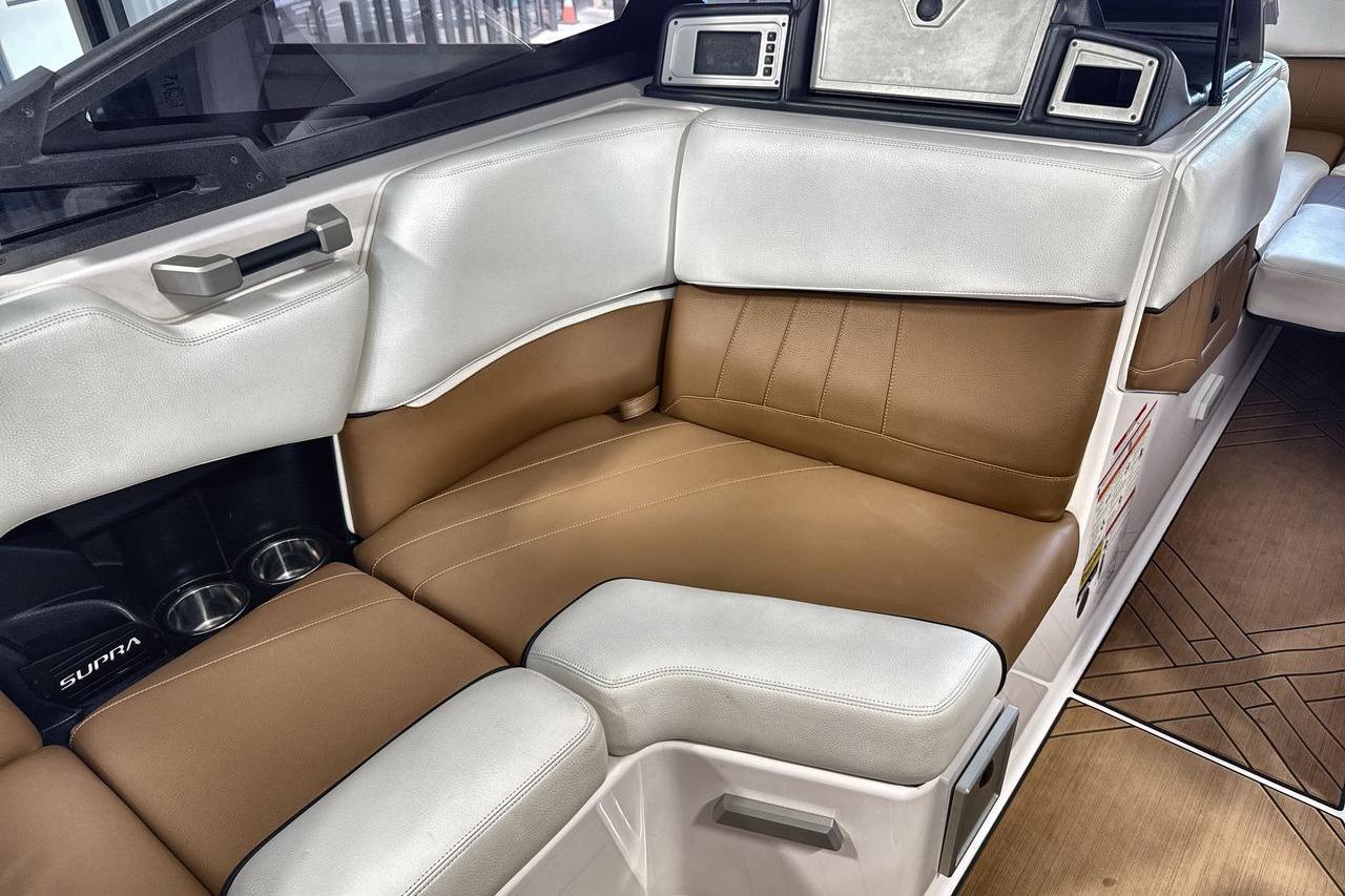 2020 Supra SE boat interior with brown and white leather seating.
