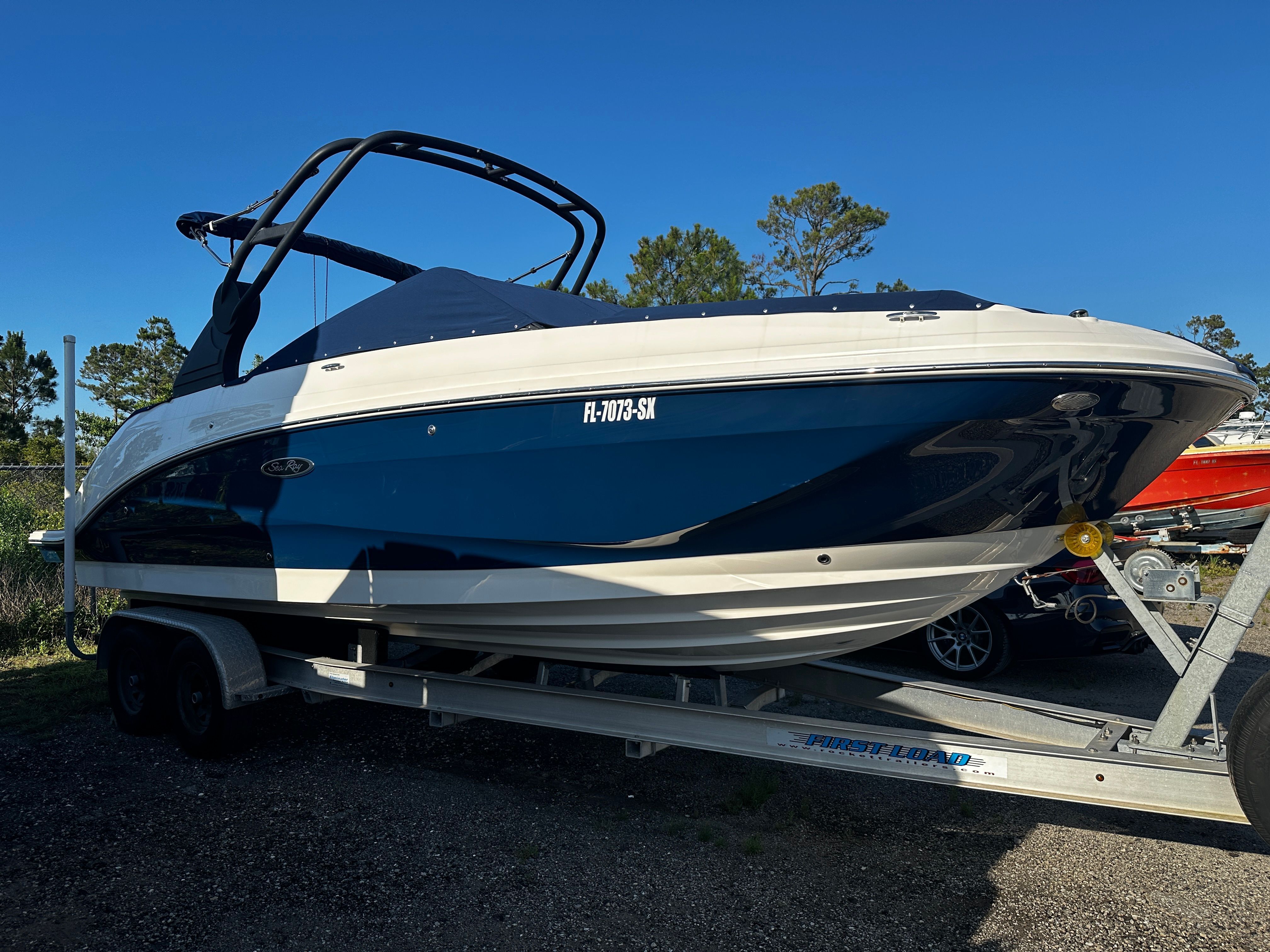 2020 Sea Ray SDX 250 Outboard on trailer, side view.