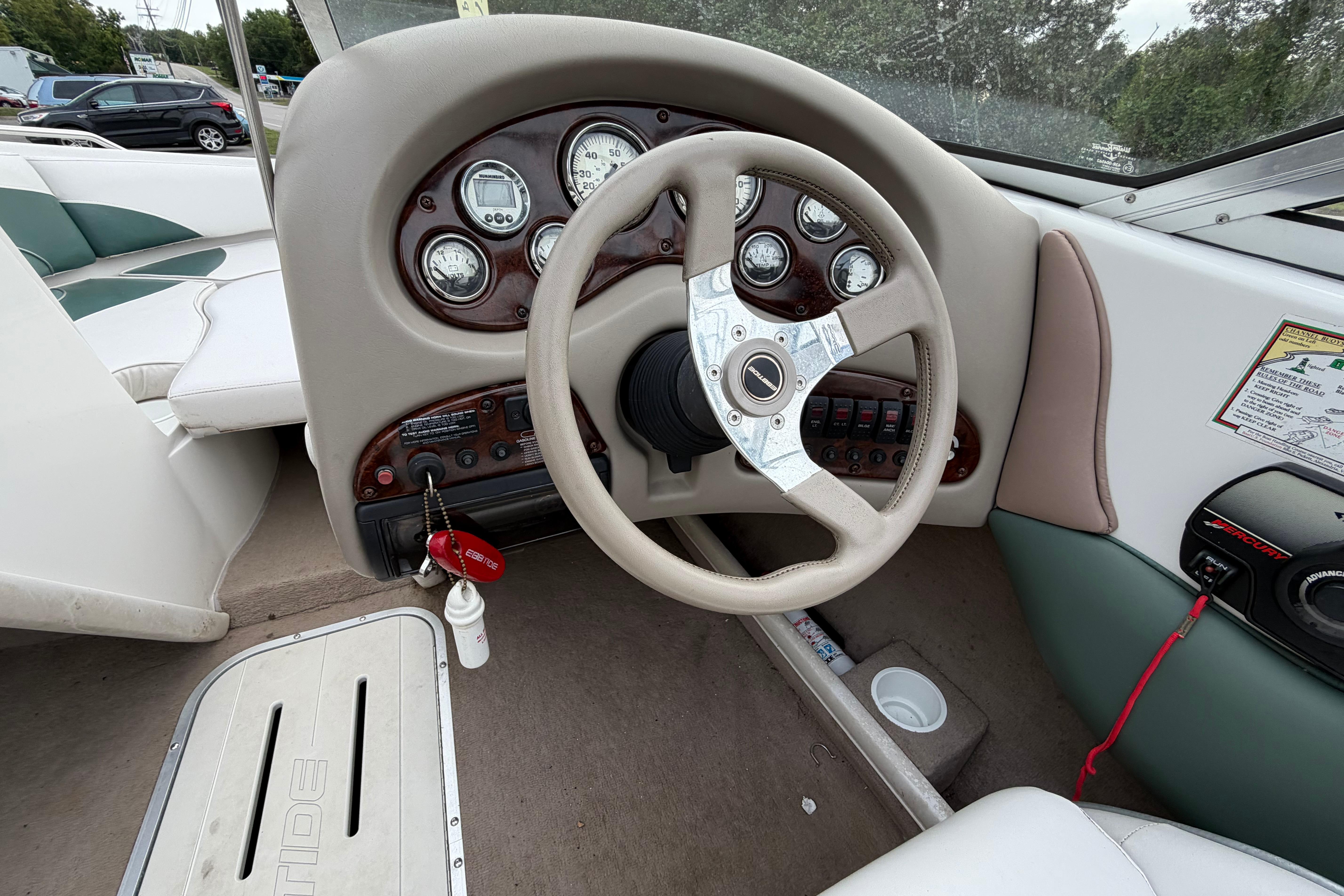 2001 Ebbtide Campione 190 boat dashboard with steering wheel and instrument panel.