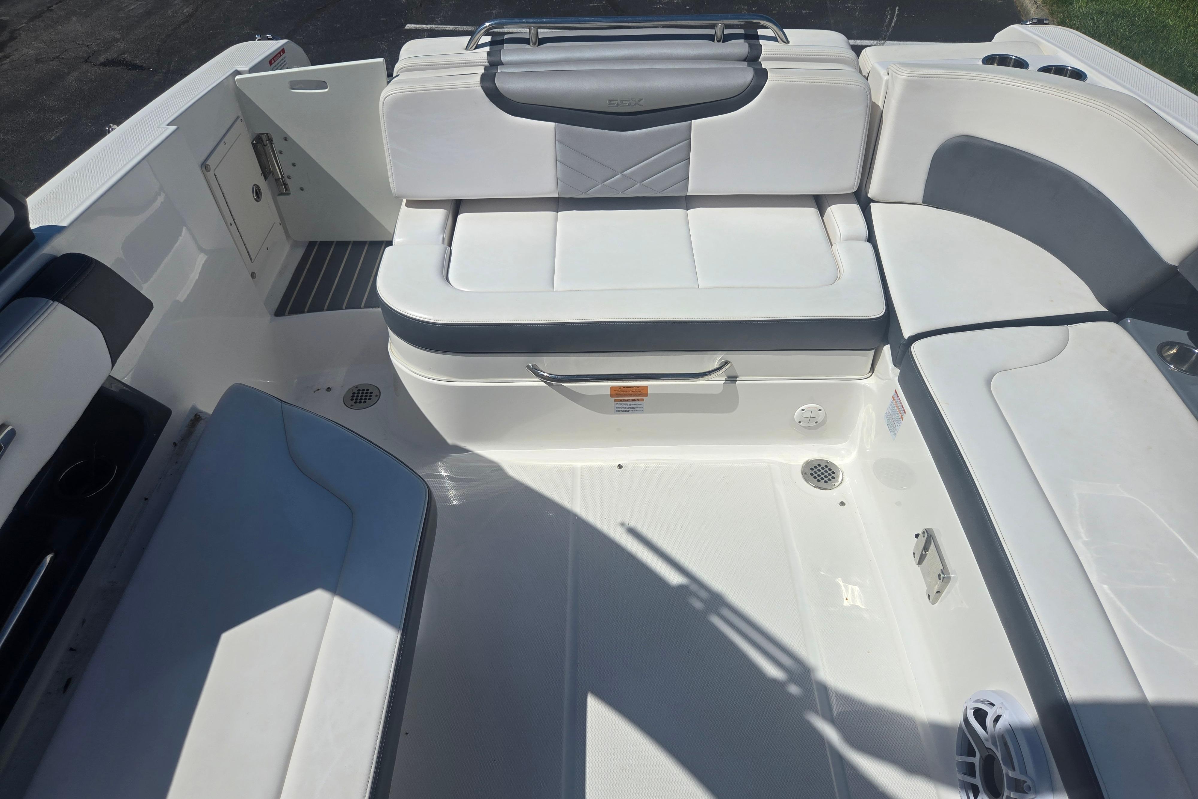2018 Chaparral 267 SSX boat interior with white seating and storage compartments.