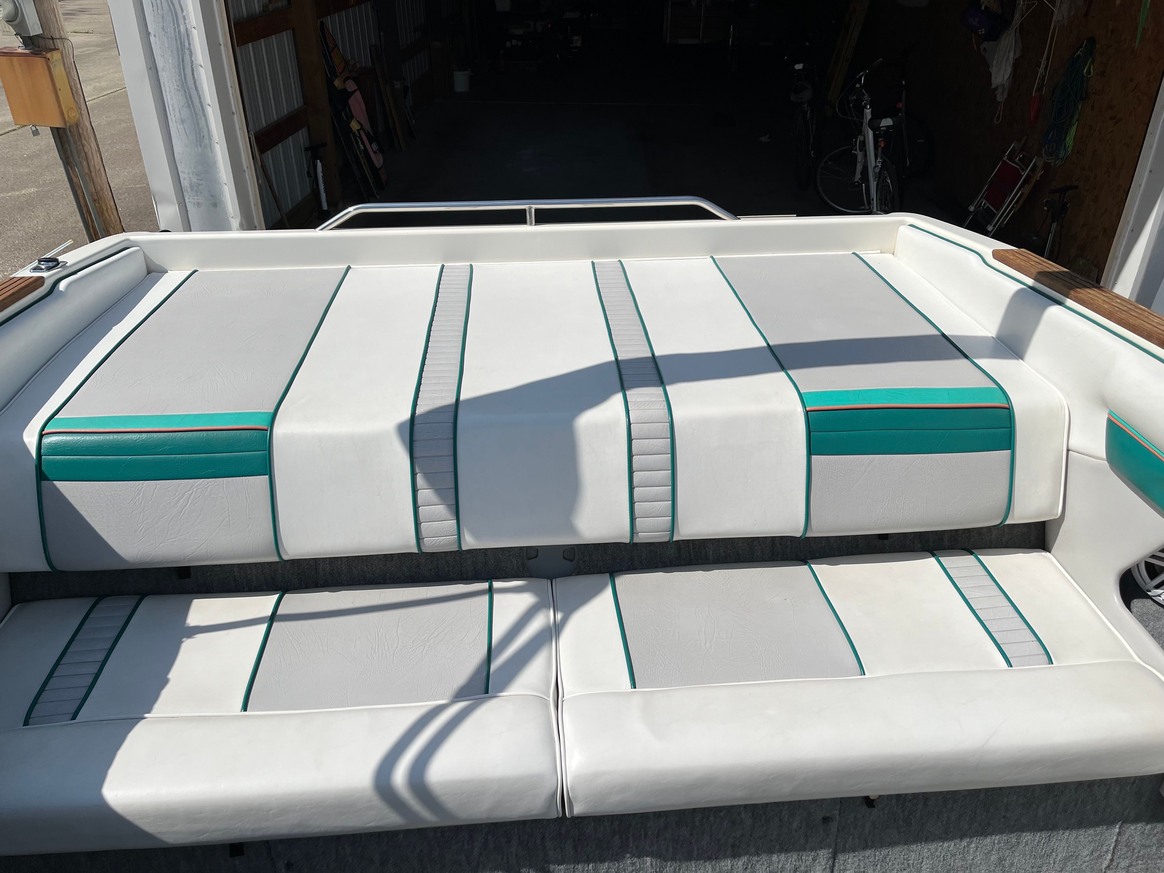 Interior view of a Sea Ray 220 Bow Rider with white and green upholstery.