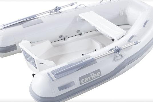 Inflatable Caribe L-8 boat, 2025 model, featuring oars and seating.