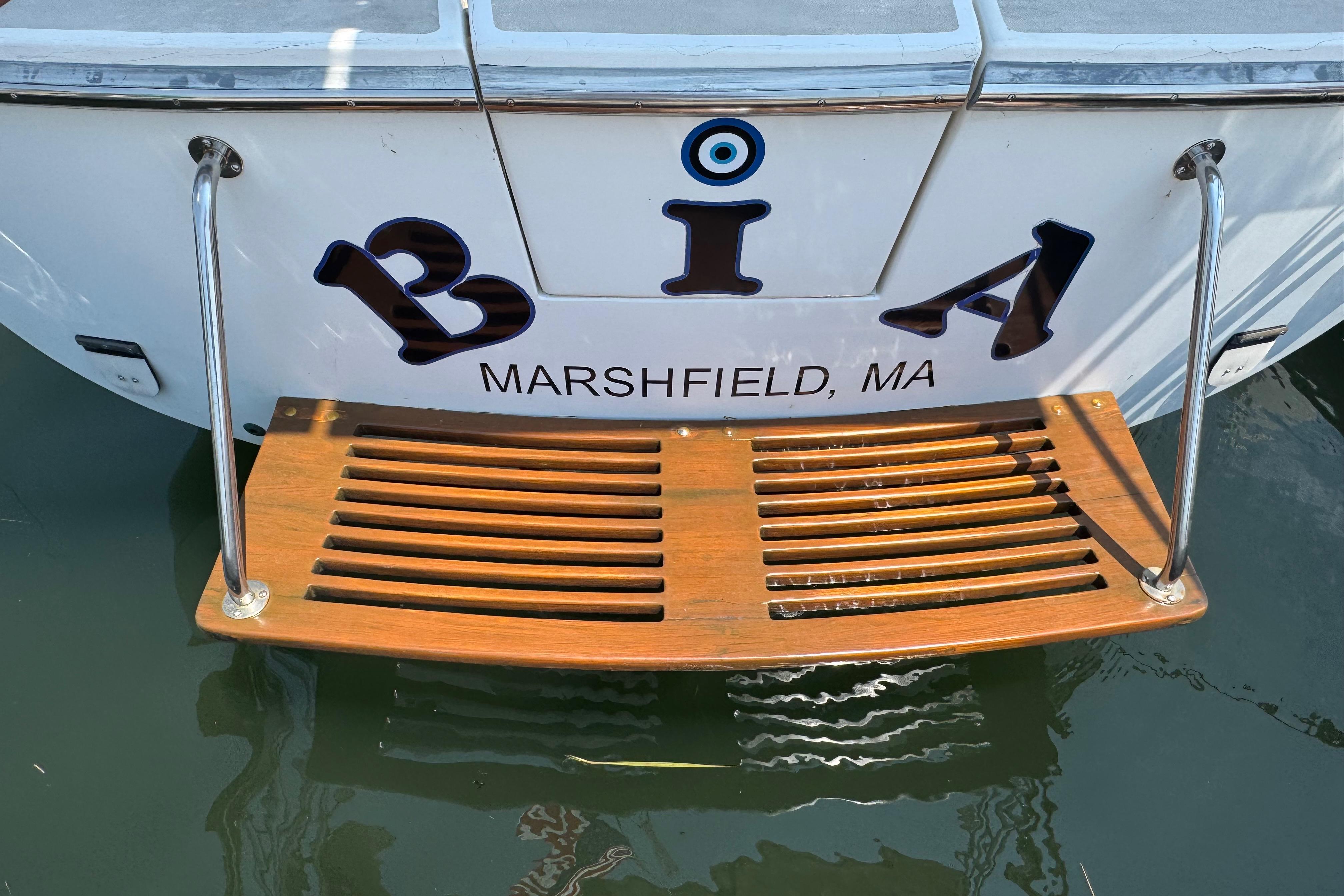 Stern of 1989 Cape Dory 30 Motorsailer with wooden swim platform, Marshfield, MA.