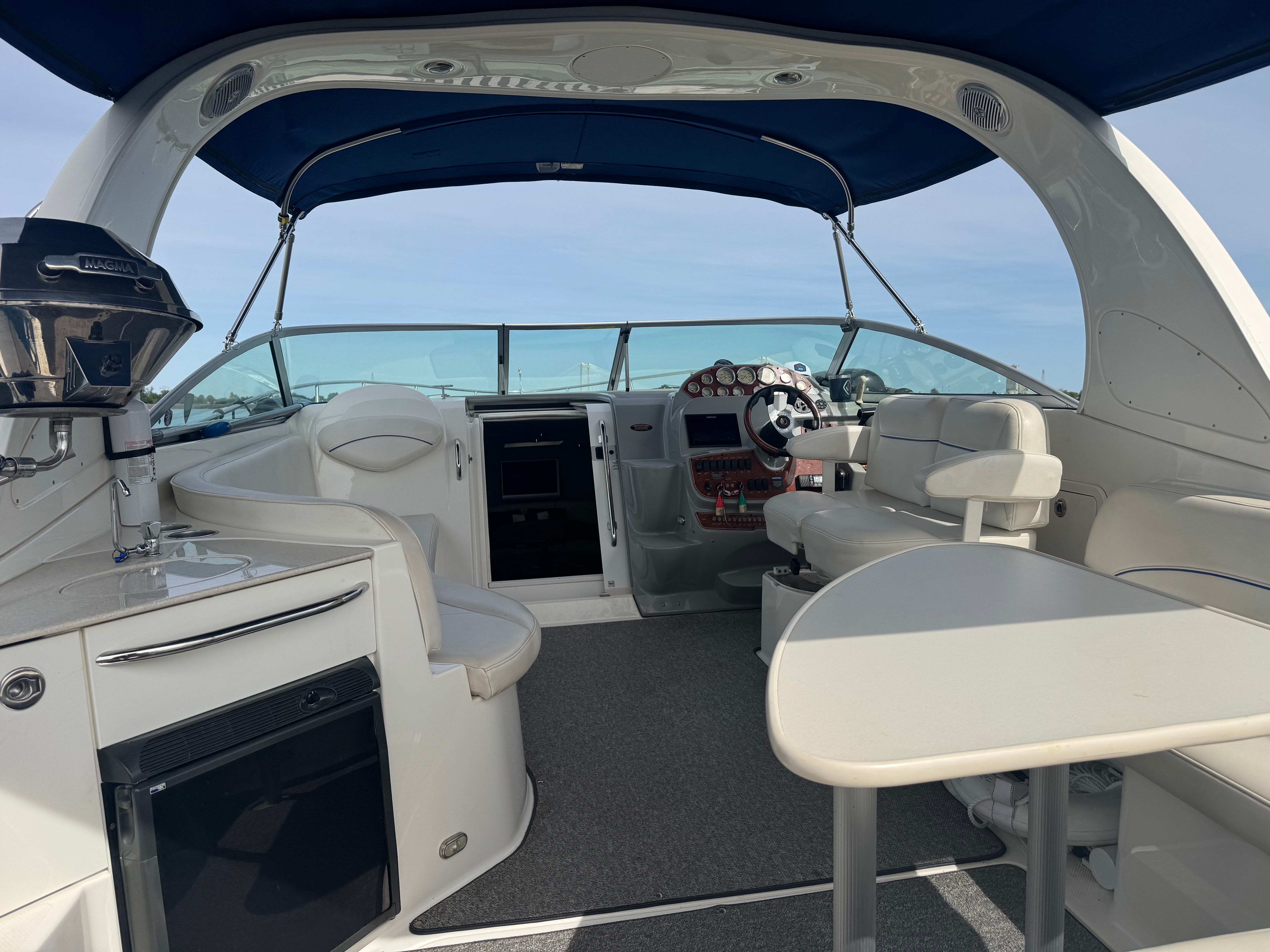 Interior of a 2008 Bayliner 340 yacht with blue canopy.