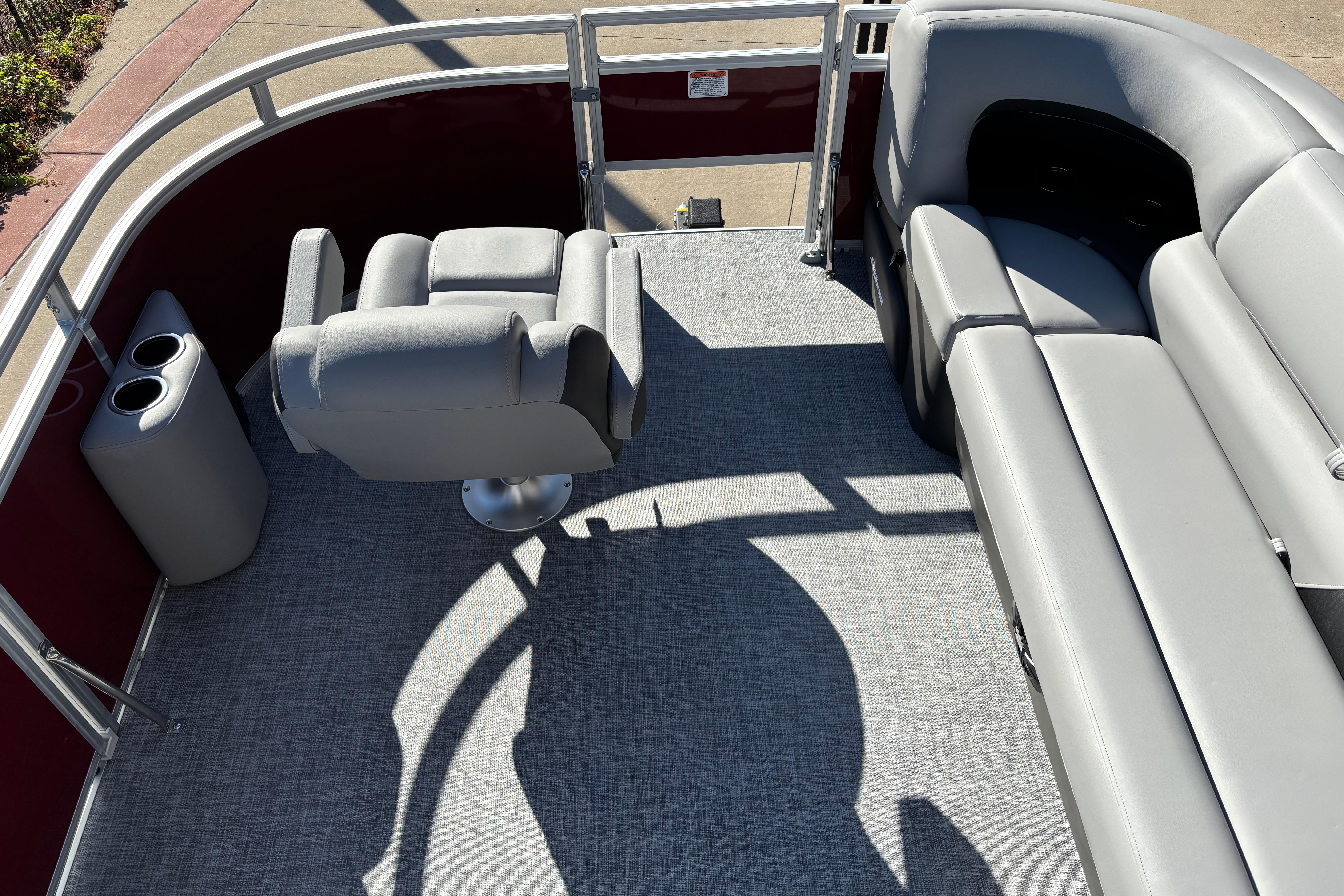 2026 Sun Tracker SportFish 20 DLX interior with gray seating and cup holders.