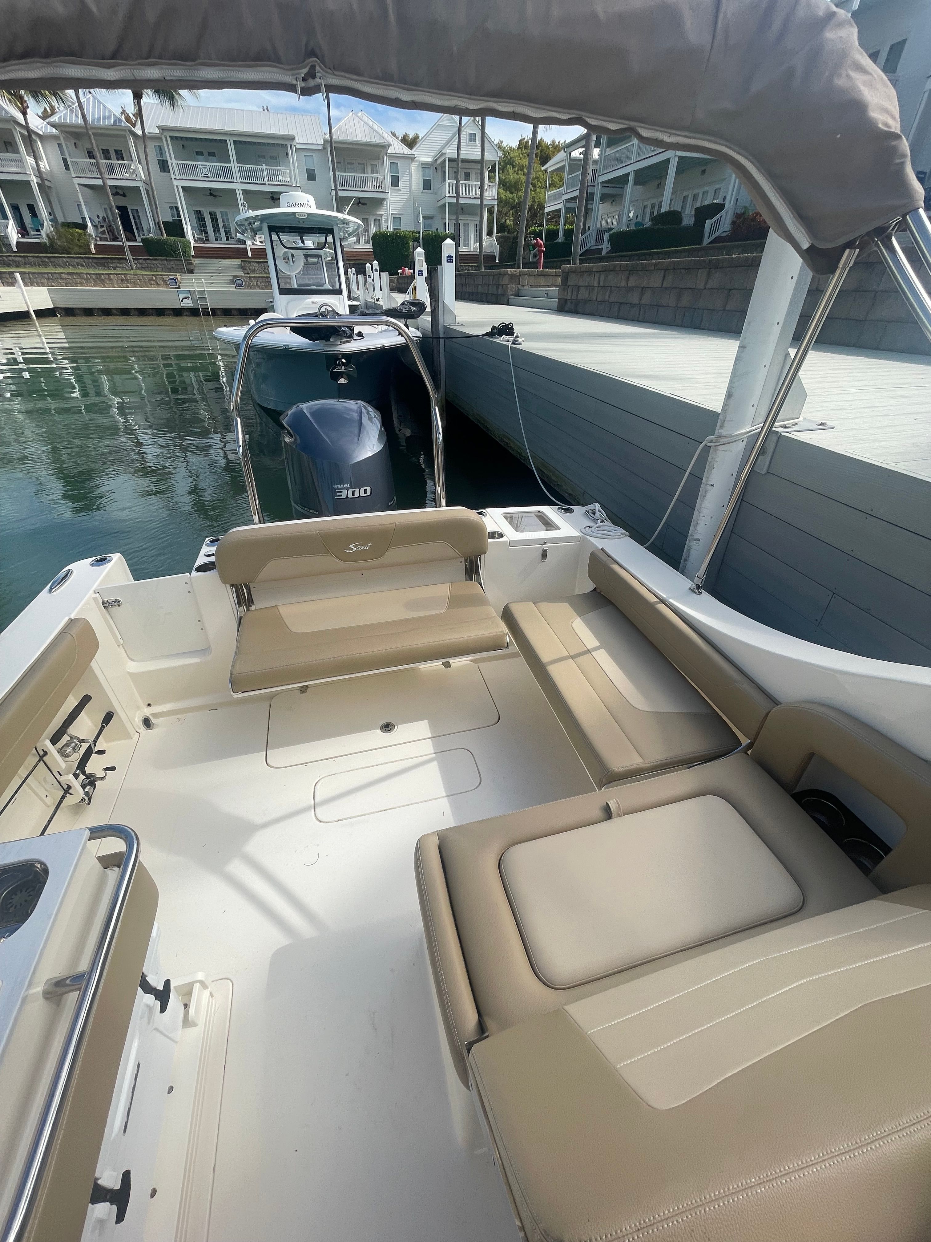 The image shows the cockpit of a 2020 Scout 235 Dorado boat with beige seating.