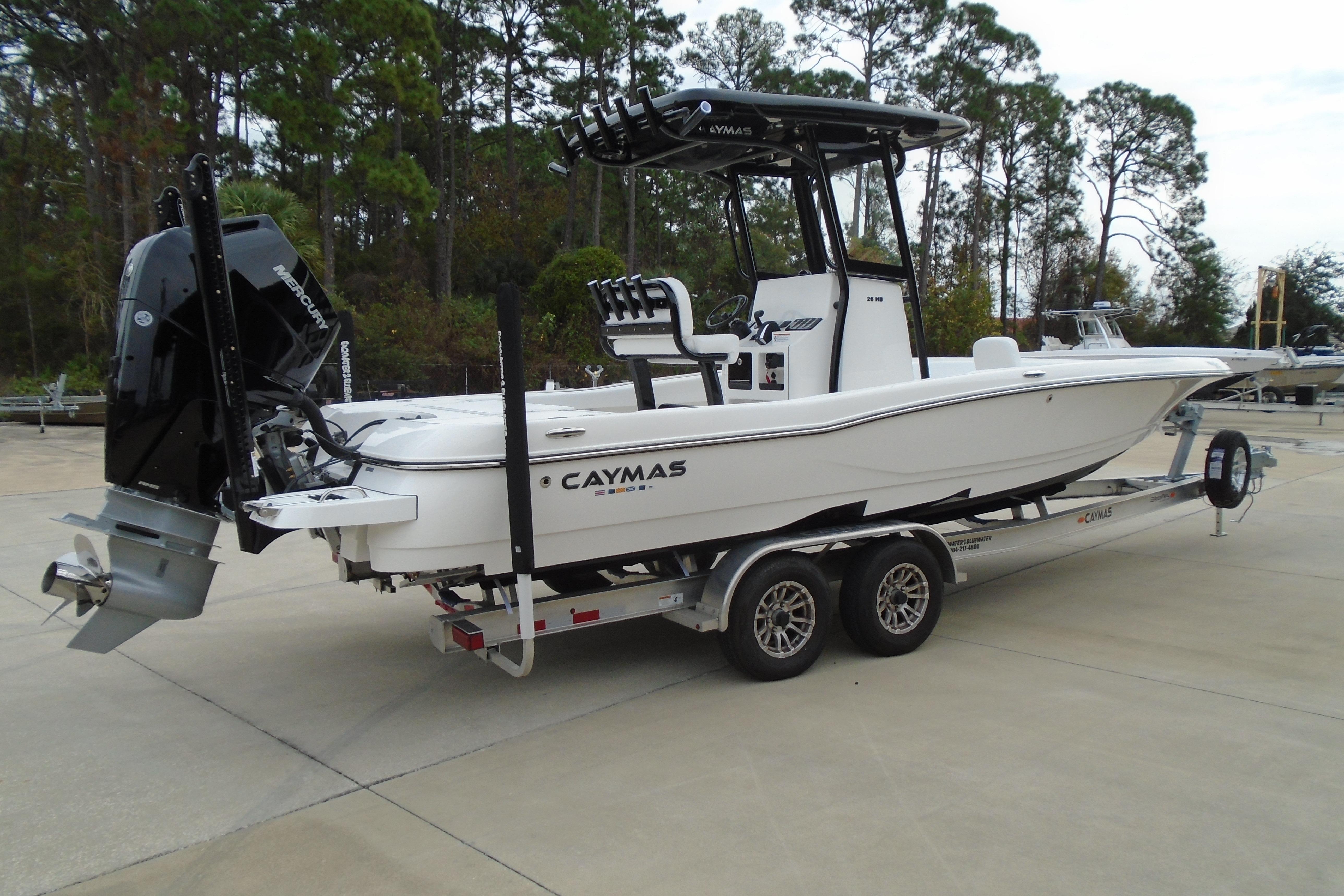 2026 Caymas 26 HB boat on trailer, featuring sleek design and powerful outboard motor.
