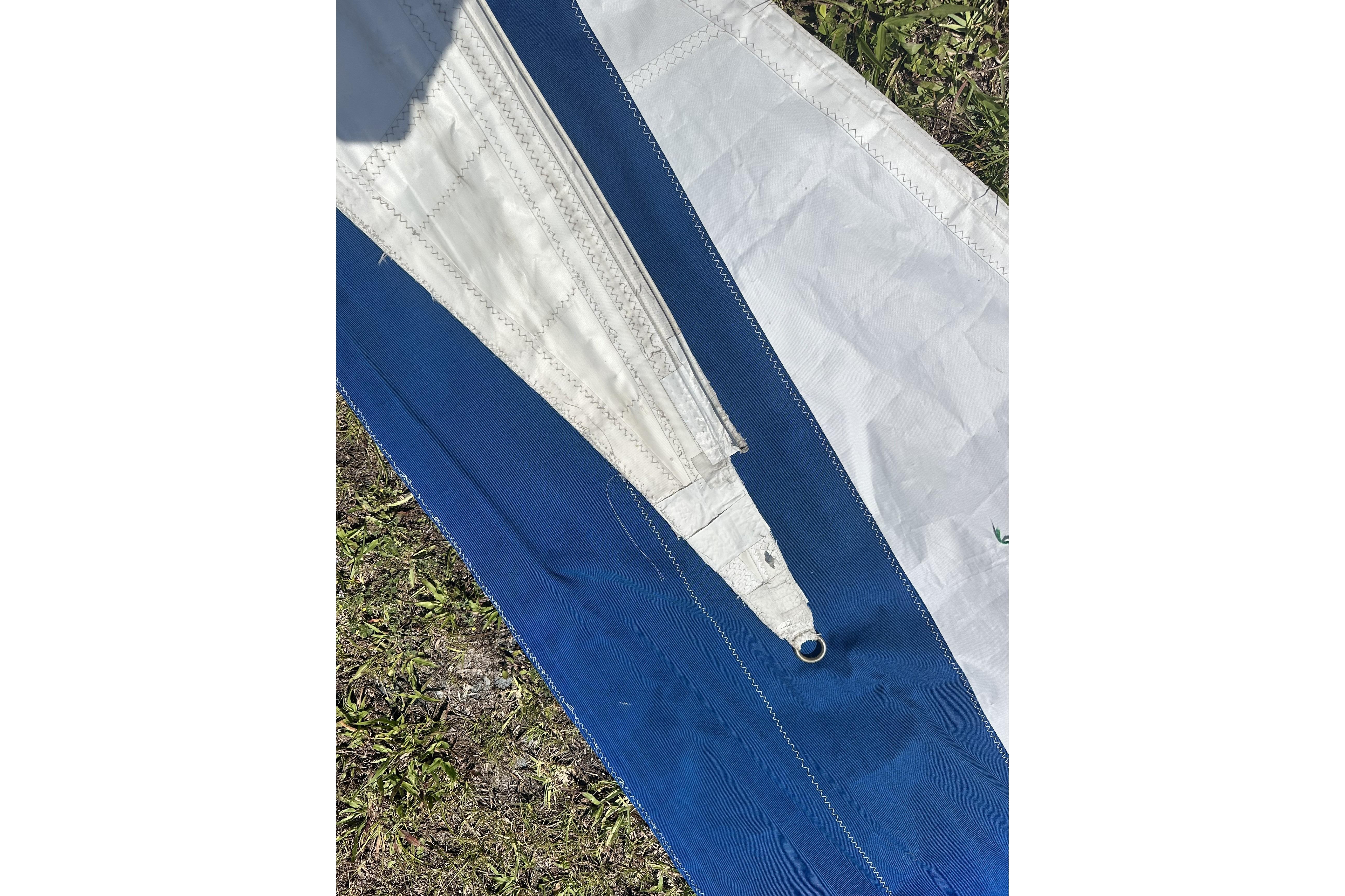 Close-up of a blue and white sail from a 1977 Ericson 36 C sailboat.